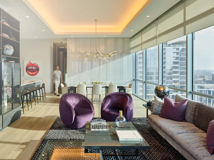 High-rise living and dining space (Seaholm Penthouse, Austin, TX): Ketra lighting, Lumaris linear fixtures, QS shades and HomeWorks QSX