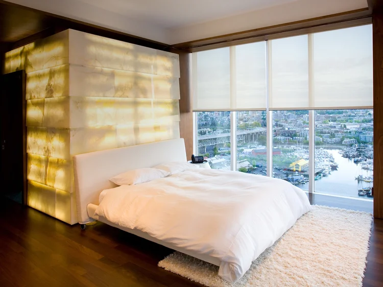 Bedroom with backlit stone wall (Lascala, Milan, Italy): Sivoia QS shades and HomeWorks QSX lighting control