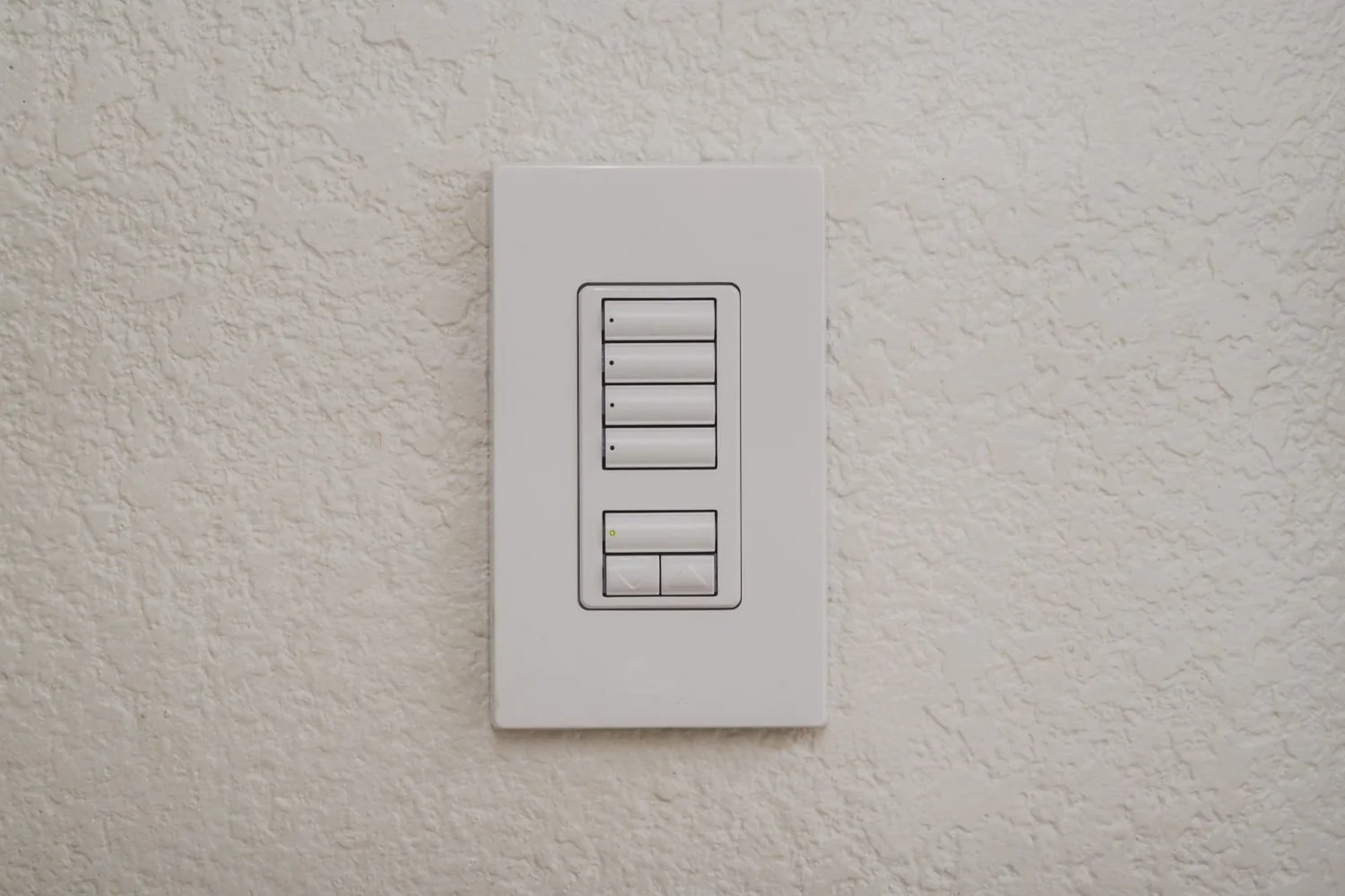 White Lutron keypad with scene buttons and a raise-lower rocker