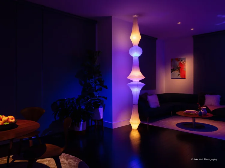 Living room with color-tunable light: Lutron Ketra lighting with a tall floor lamp