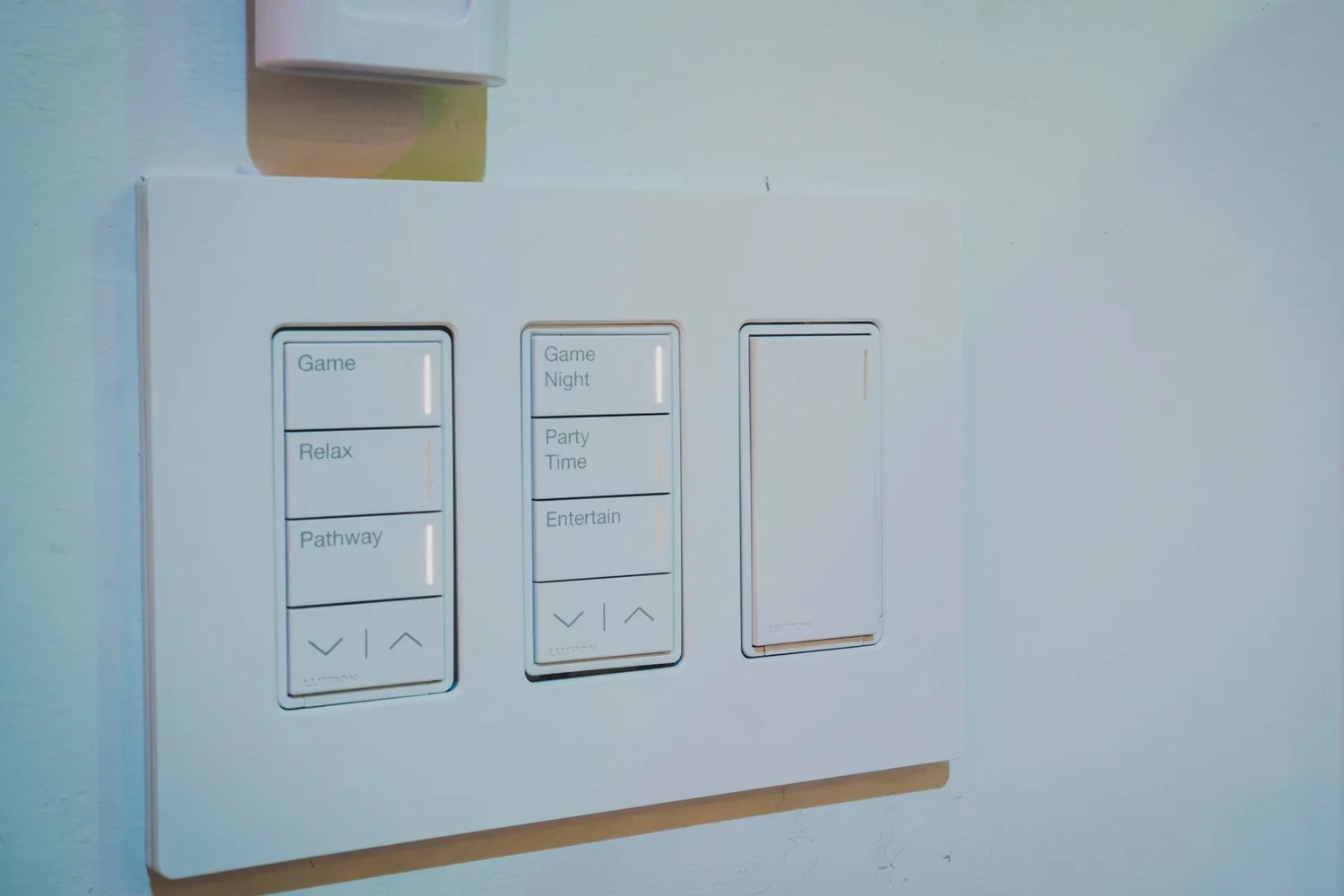 Lutron Sunnata keypads and dimmer on a white wall