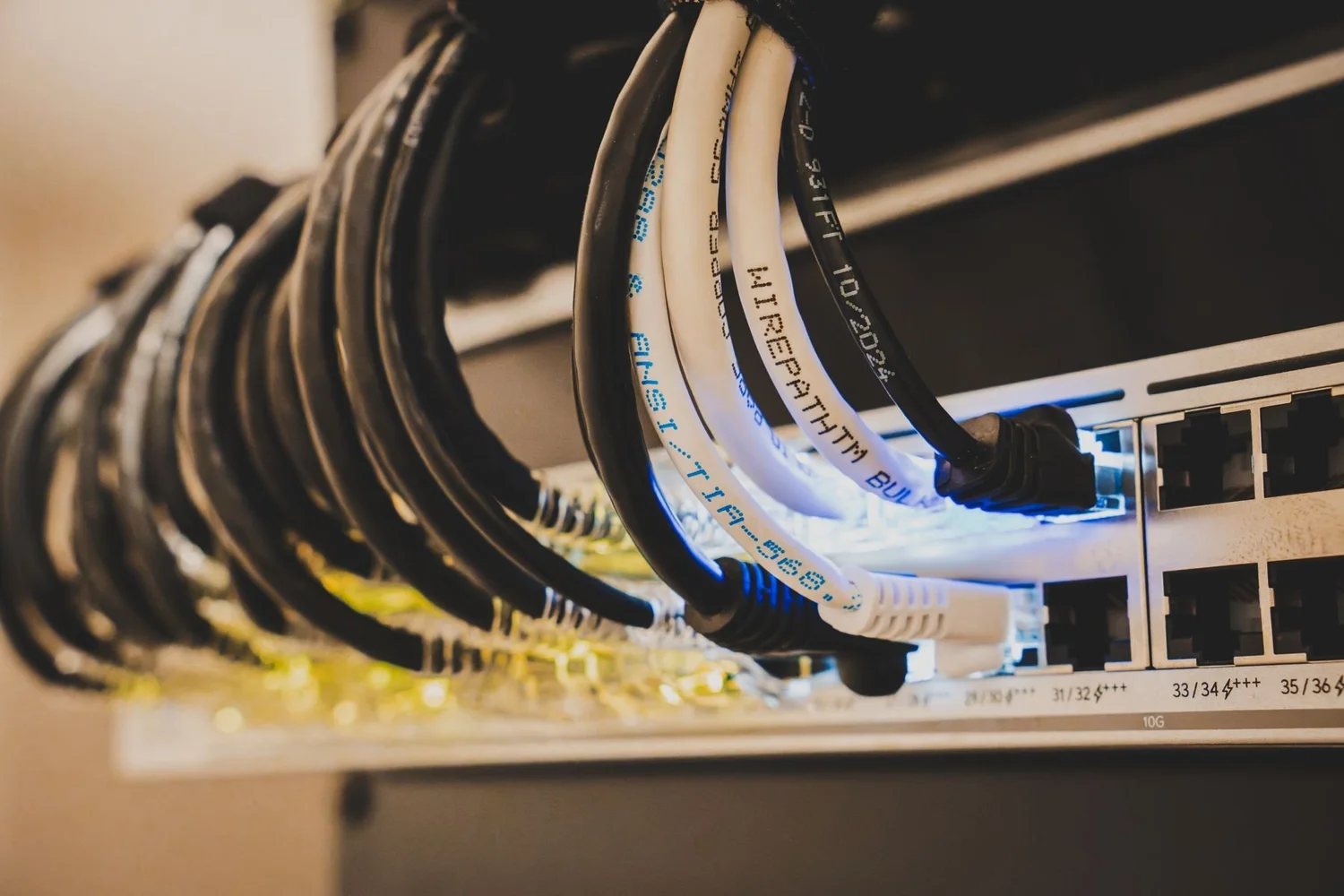 Patch cables routed from the top of a rack into a network switch