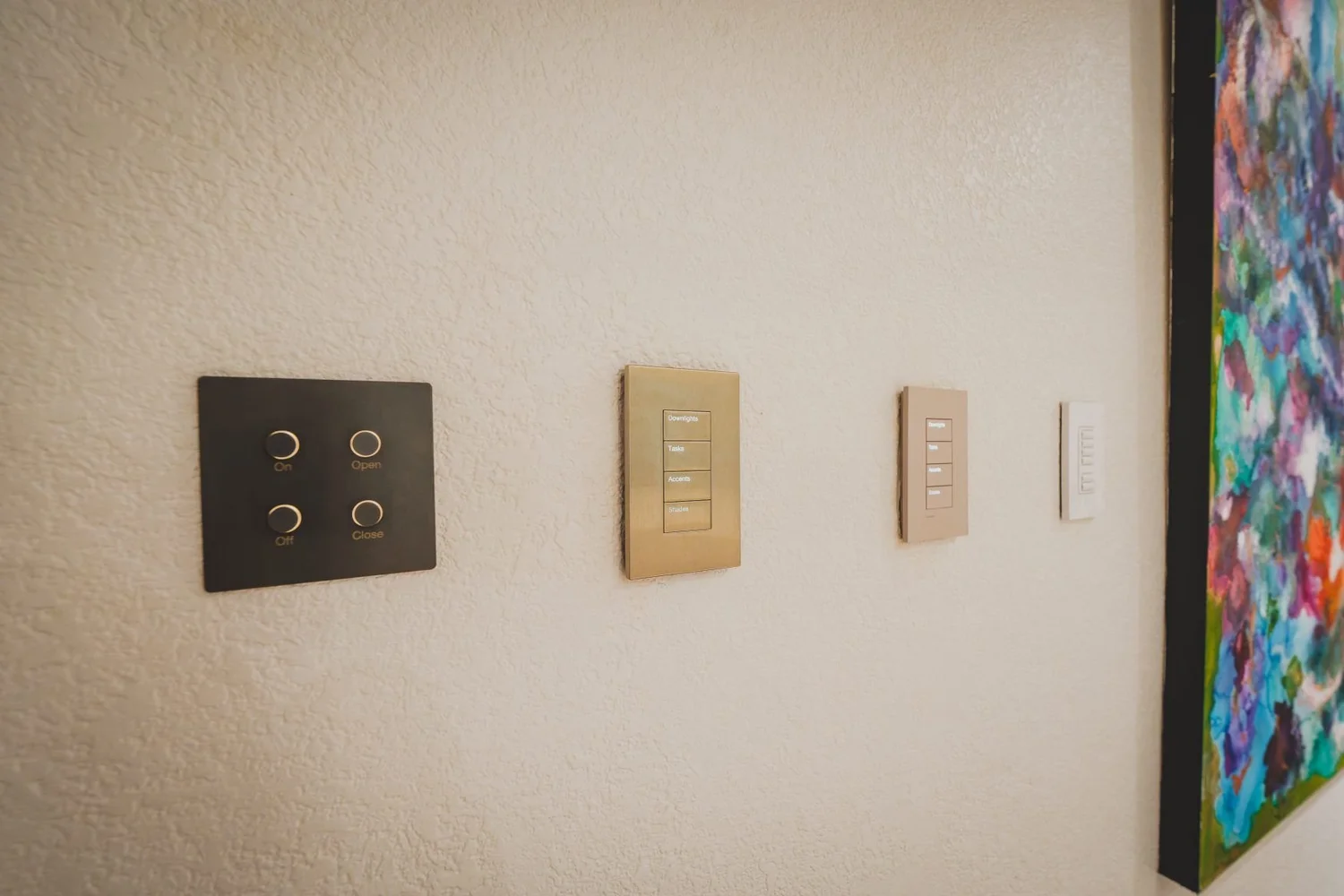 Four Lutron keypad styles mounted on a showroom wall