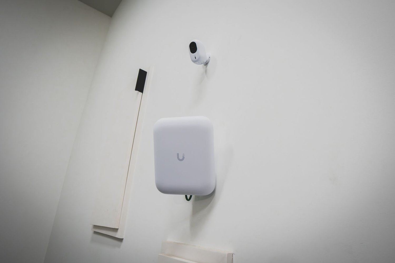 Wi-Fi access point and security camera on a wall