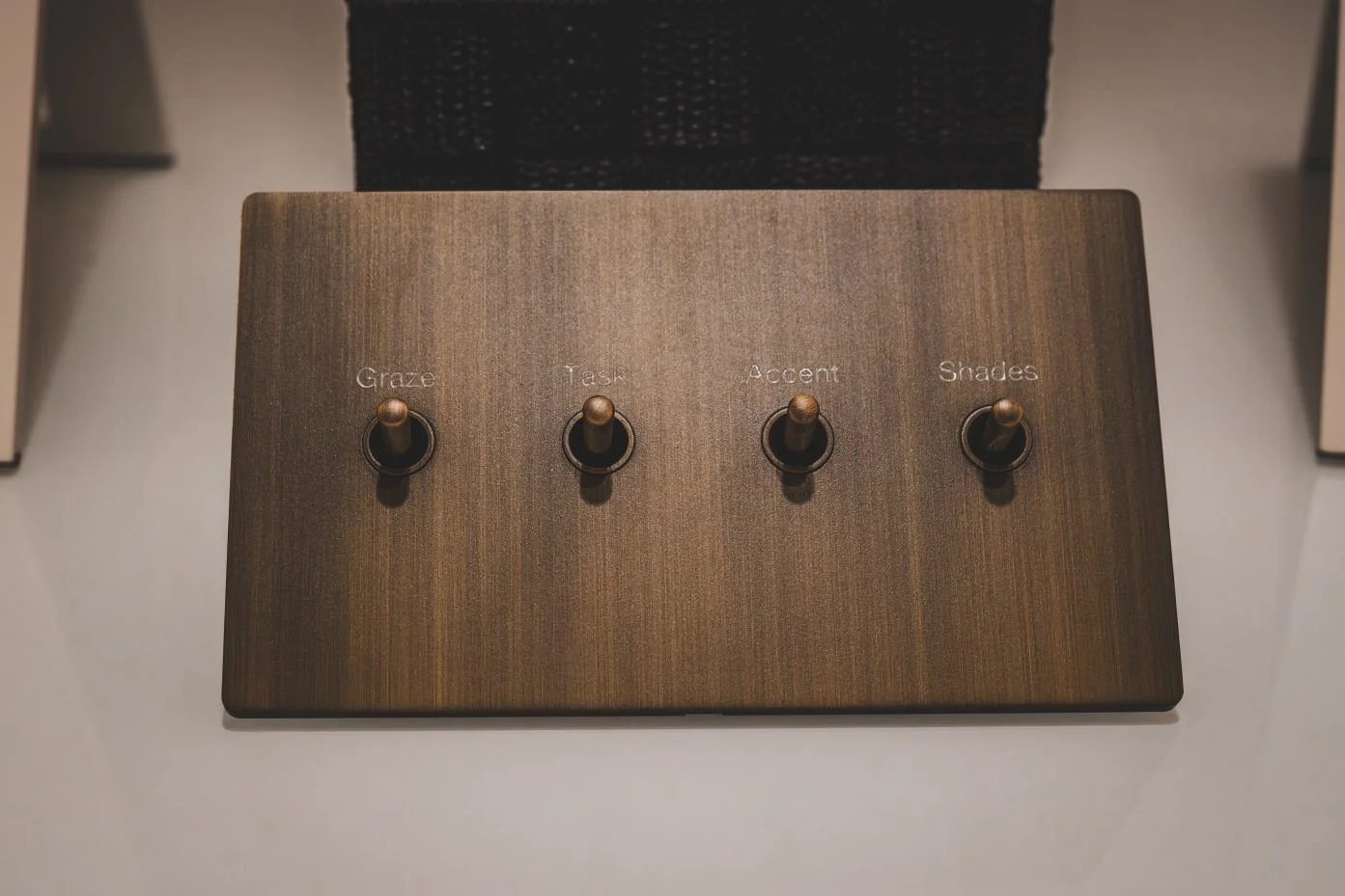 Brass wall plate with four toggle switches