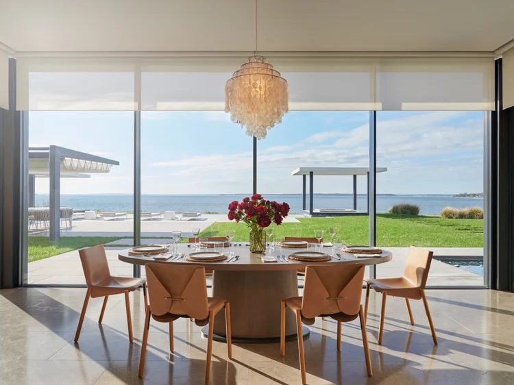 Dining room with ocean views (Sag Harbor Residence, Sag Harbor, NY): Ketra lighting and Lutron QS roller shades