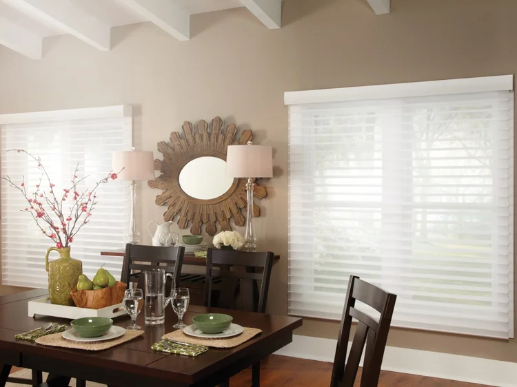 Dining room with sheer shades (Private Residence): Lutron motorized sheer shades and table lamps