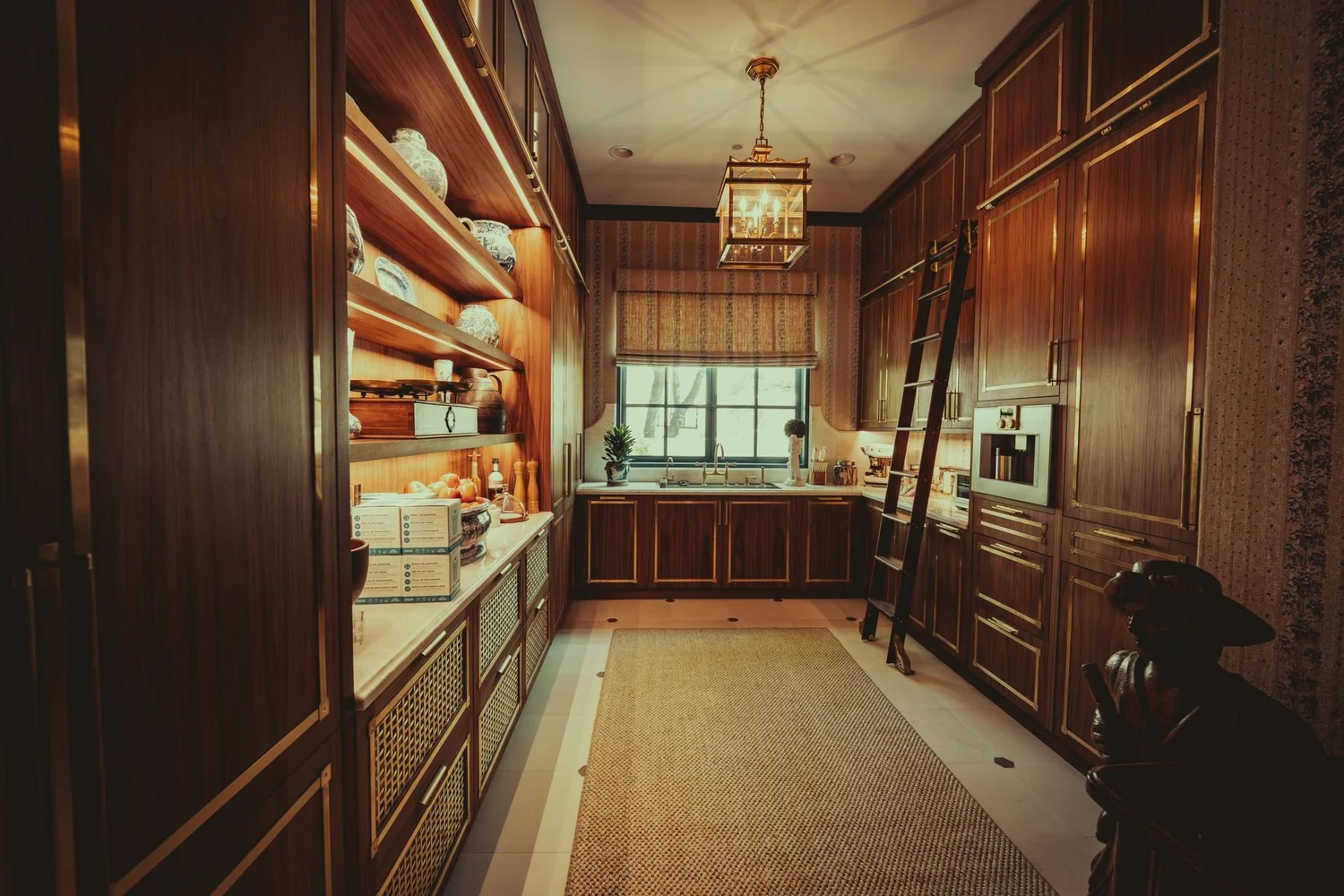Walk-in pantry with lit shelves and a pendant light