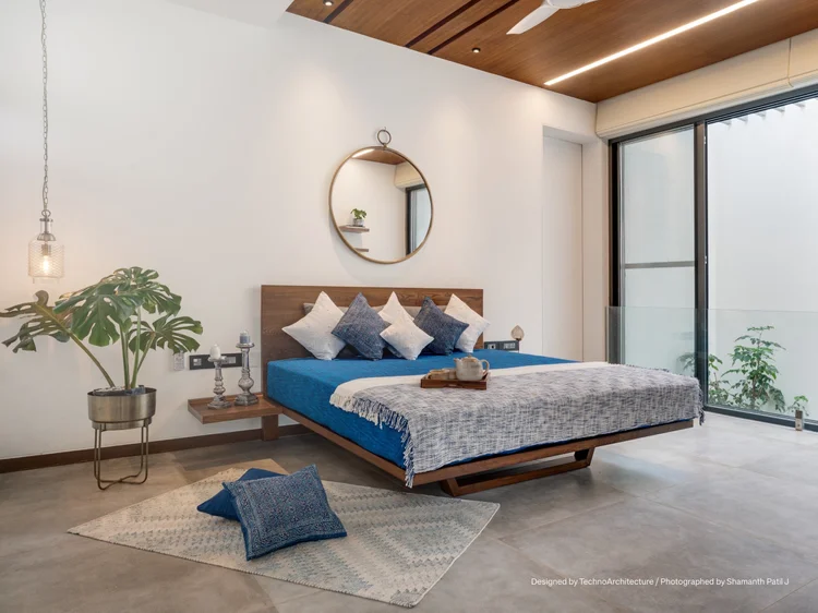 Bedroom with linear lighting in a wood ceiling: Lumaris linear lighting and Ketra G2 linears