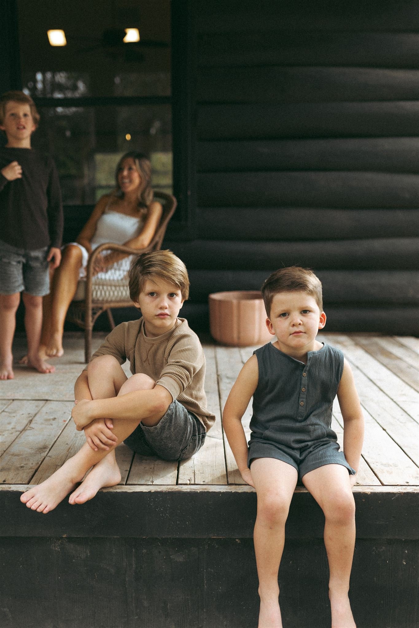  Dallas family photos outside on the front porch, two little boys sit looking at the camera 