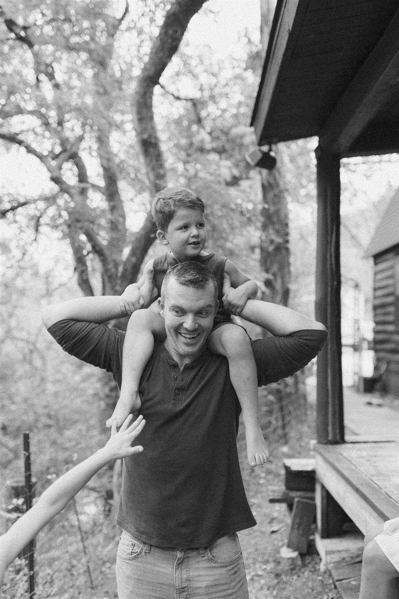  a little boy on his dad’s shoulders 