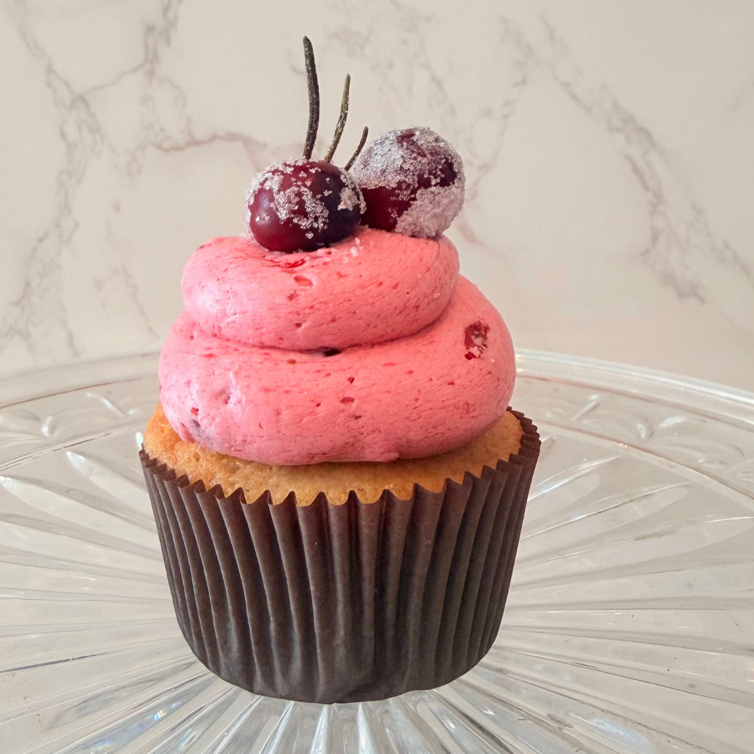 Chocolate cupcake with a swirl of white frosting on top.