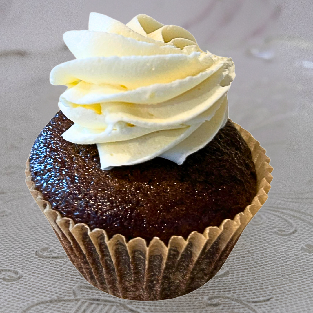 Chocolate cupcake with white frosting on top.