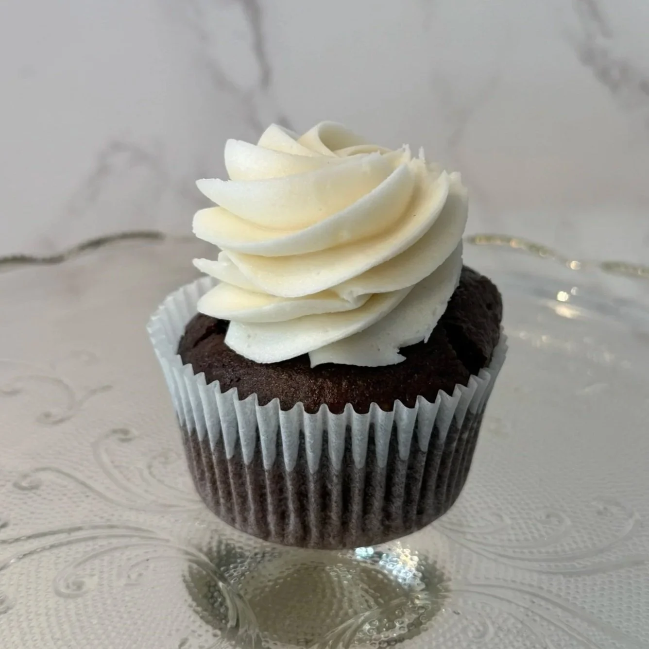 Chocolate cupcake with white frosting on top