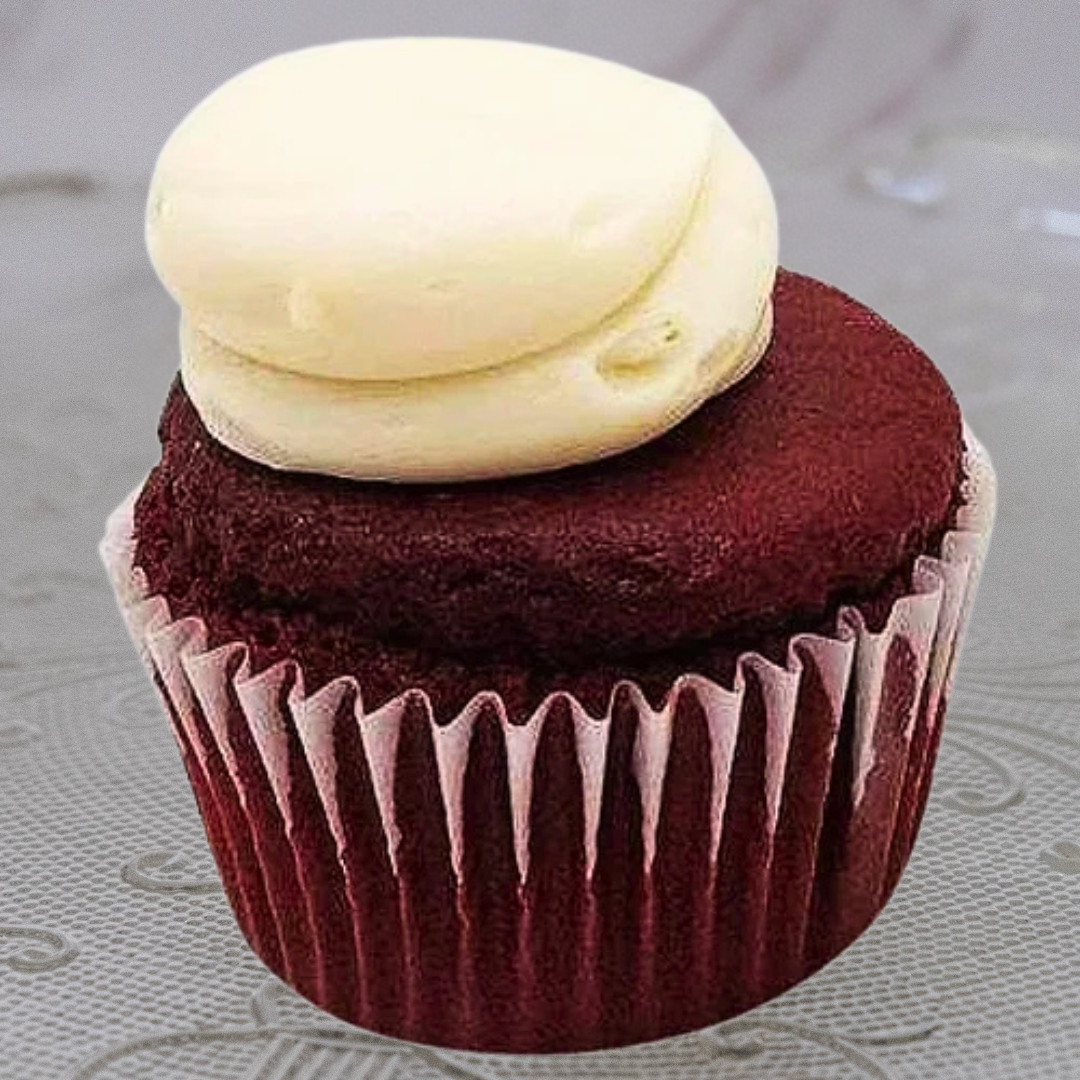 Vanilla cupcake with swirled white frosting on top.