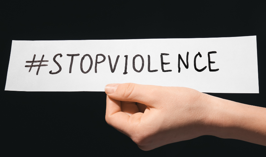 hand holding a paper saying stop violence