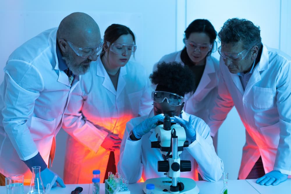 scientists-observing-young-female-colleague-using-2025-04-01-18-24-41-utc (1) (1).jpg