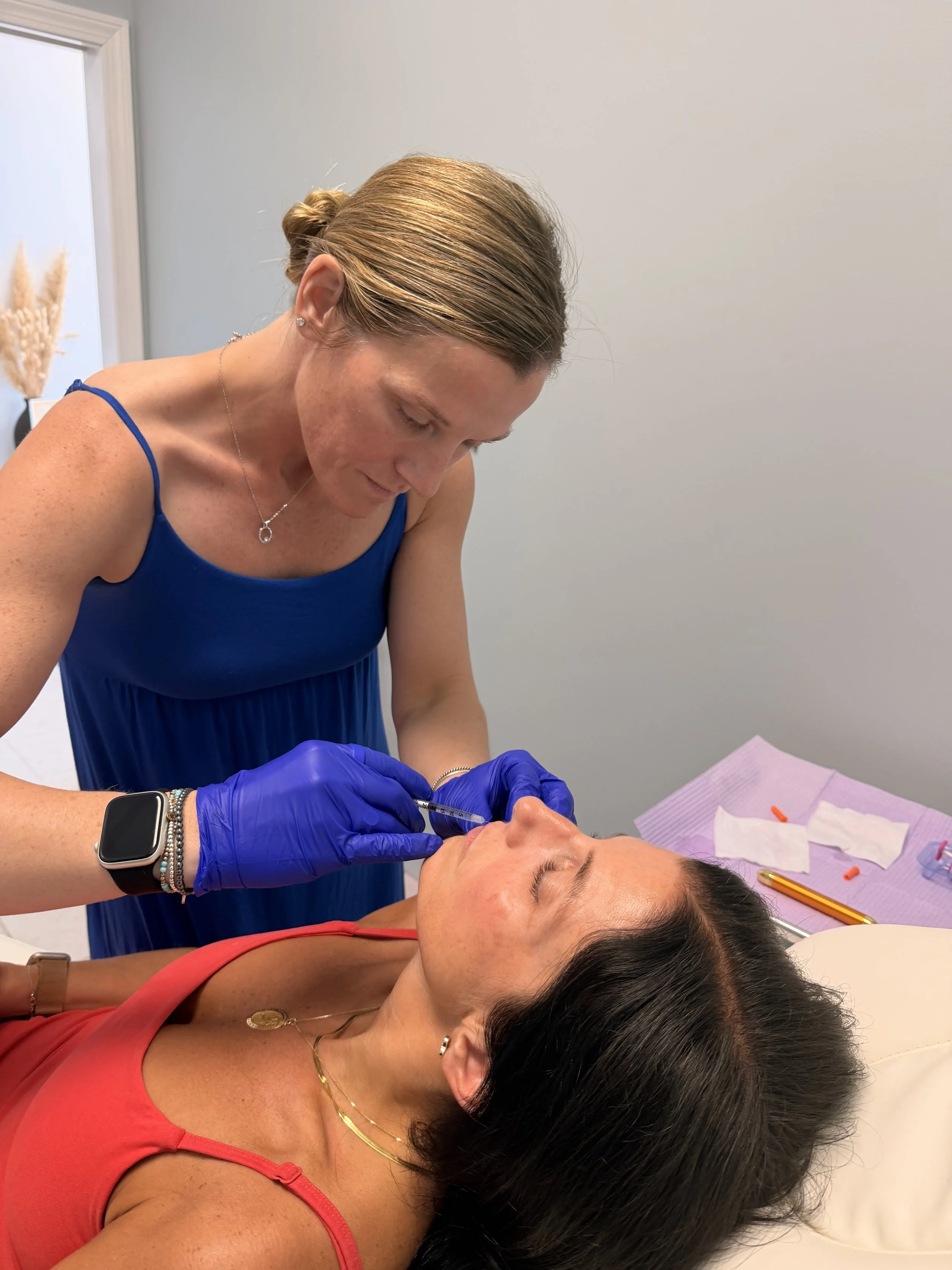 Kristen Sloboda injecting lip filler to add volume and reduce fine lines and wrinkles around the mouth area.