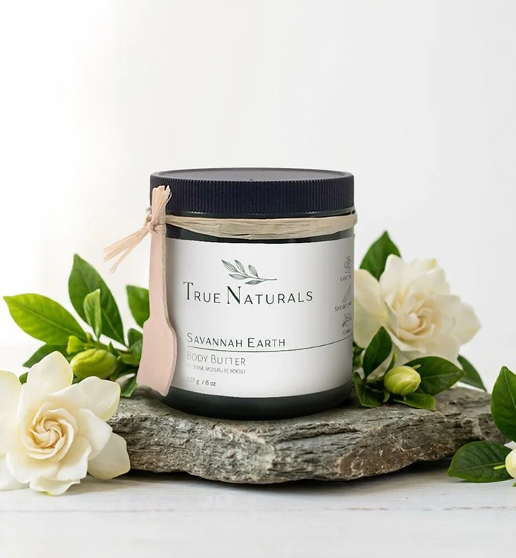 True Naturals Savannah Earth Body Butter with gardenia flowers. Pure plant-based skincare with the power of essential oils.