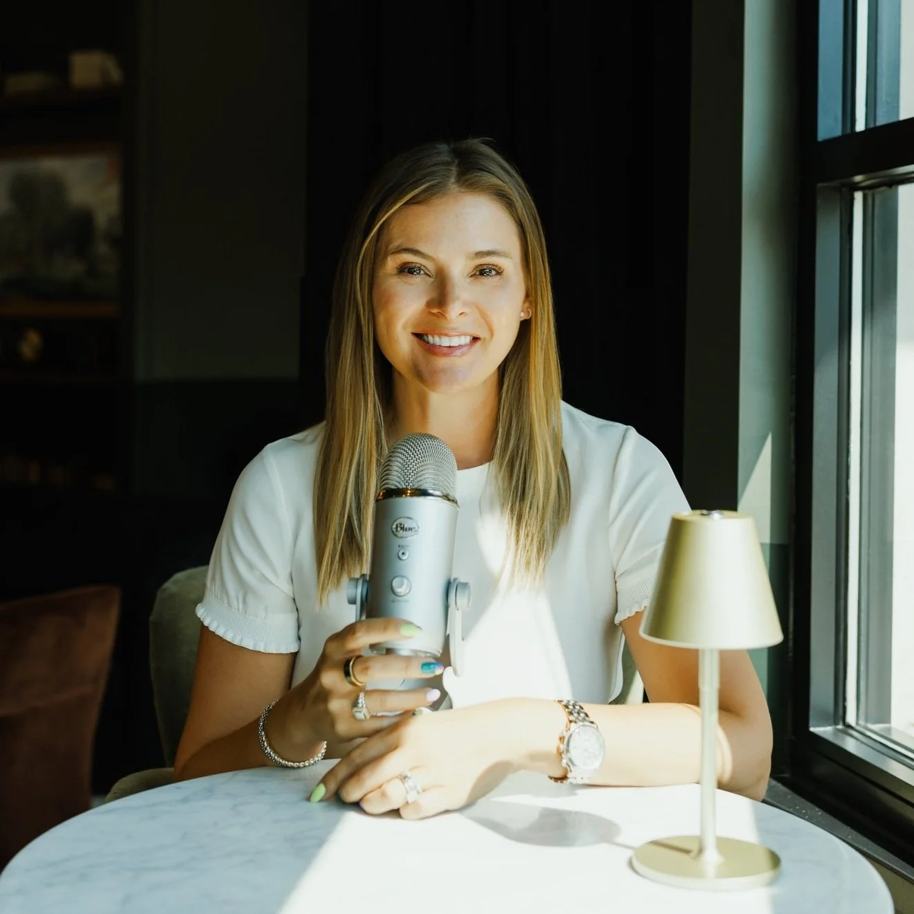 Headshot of Missouri podcast host Kerri M. Roberts with microphone for Don't Waste the Chaos