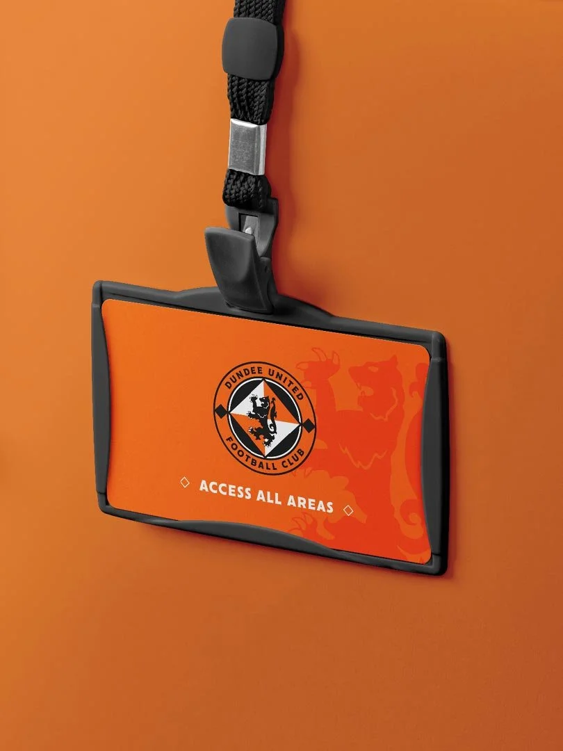 An orange and black access pass with the Dundee United Football Club logo, hanging from a lanyard on an orange background, with the text 'Access All Areas'.