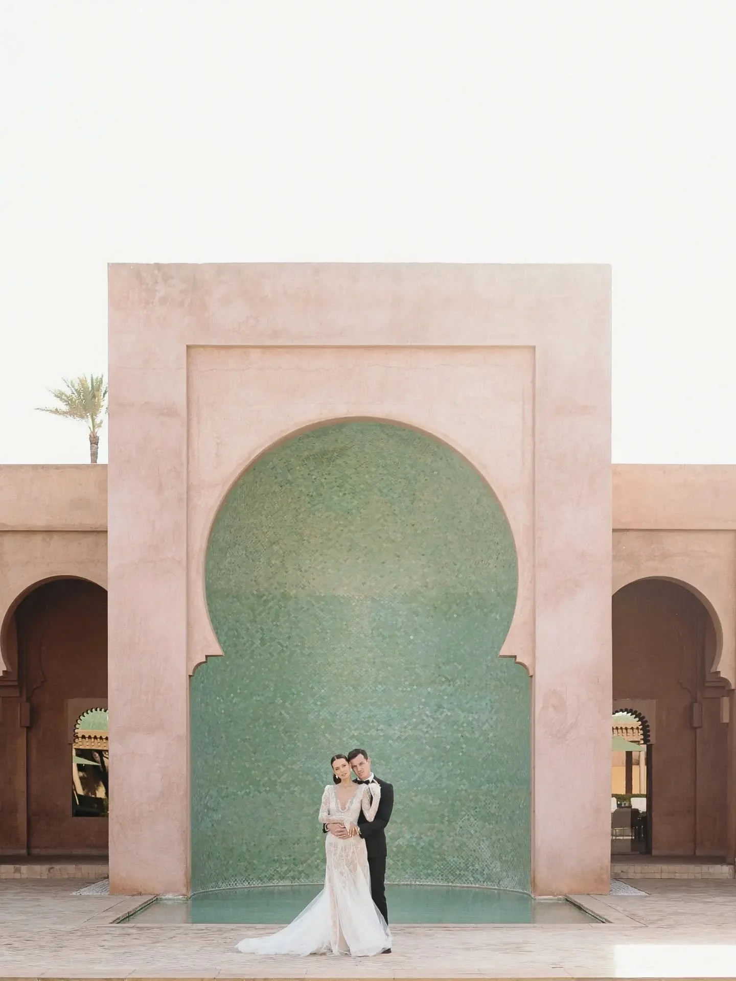 Pink &amp; green.

That's the whole thing at the Amanjena, &amp; nobody had to arrange it. The rose is in the raw earth of the walls, the terracotta that goes warm the second the sun touches it. The green sits inside the keyhole niches, that emerald 