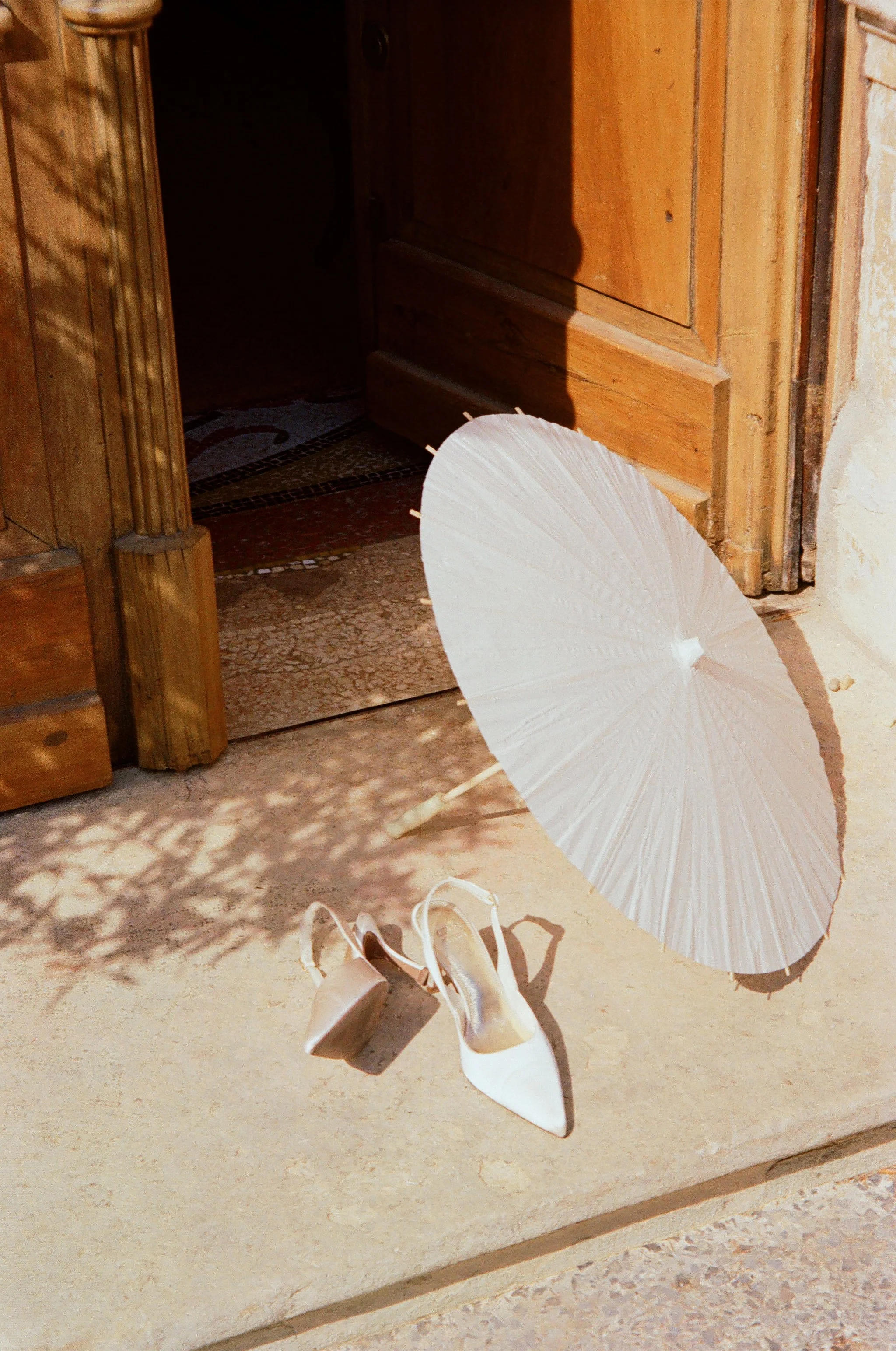 Film photography editorial wedding detail at Jardins de Campagne, a private villa near Nîmes in the South of France by Cleya Asulon, destination wedding photographer for Nîmes, Provence and the Occitanie region — quiet still life of ivory satin point
