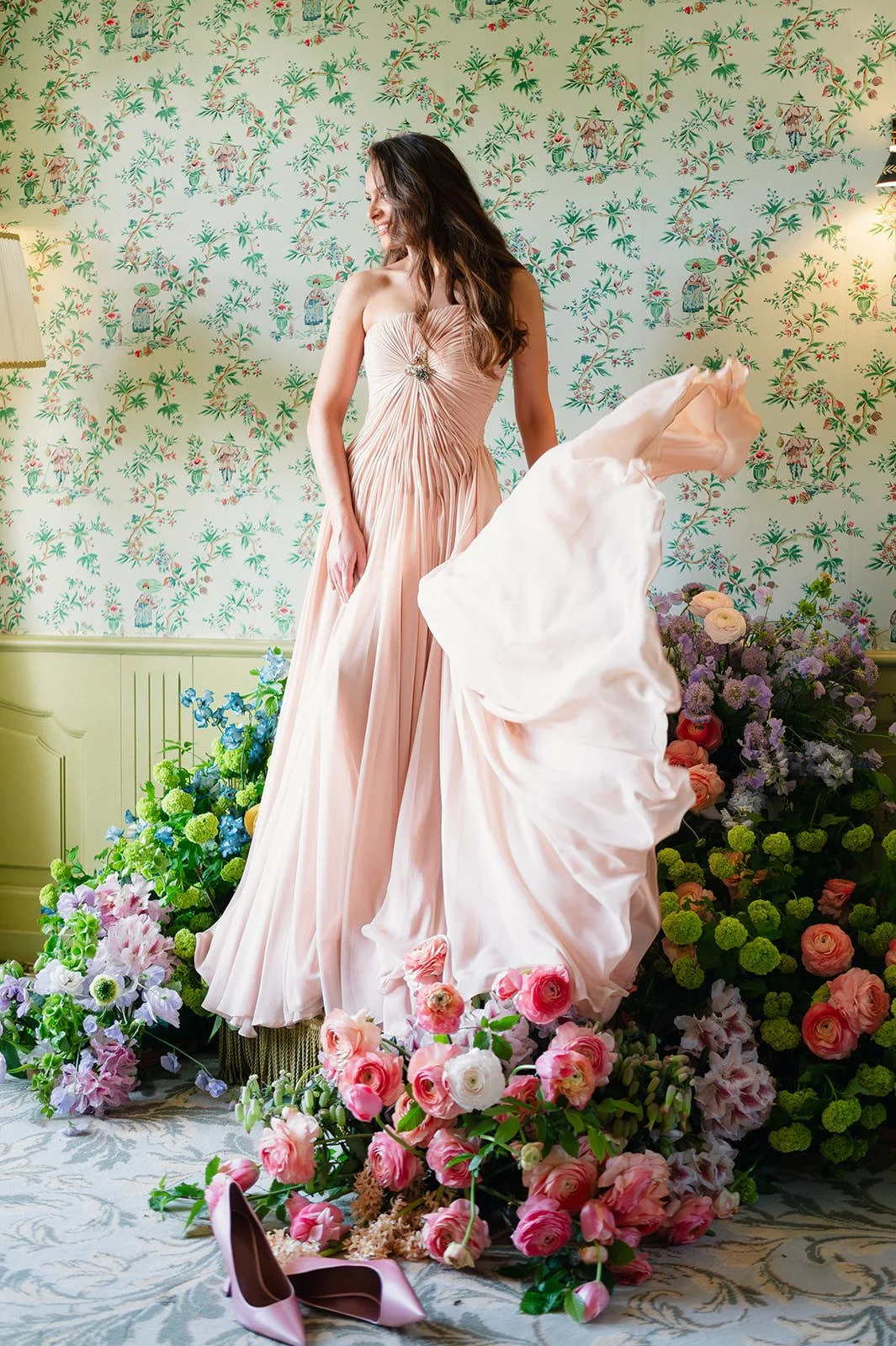 Editorial bridal portrait at Château de Mirambeau (Gironde, France) by Cleya Asulon, destination wedding photographer based in Bordeaux and Cognac — bride twirling in a blush pink strapless draped chiffon gown with jewelled bodice detail, standing ba