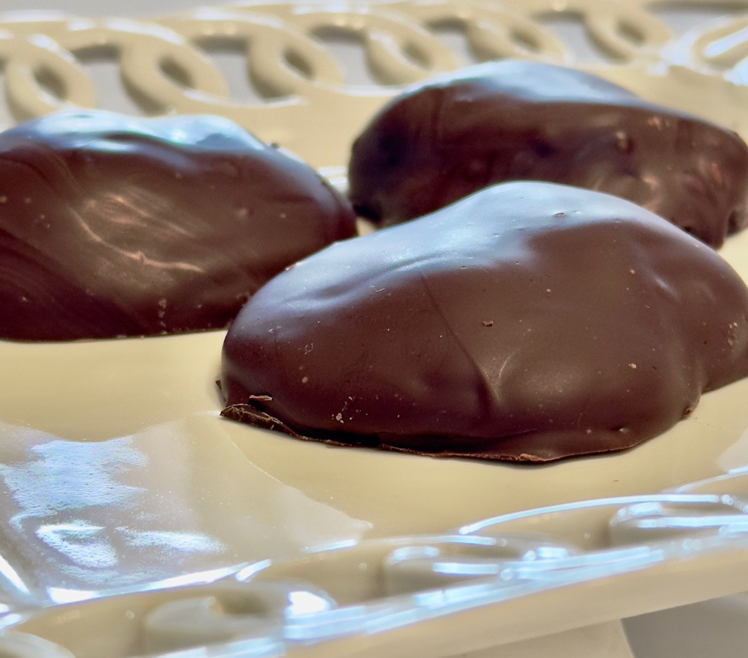 Image of Duo Drops chocolate covered sugar roasted pecans wrapped in caramel and dipped in chocolate.
