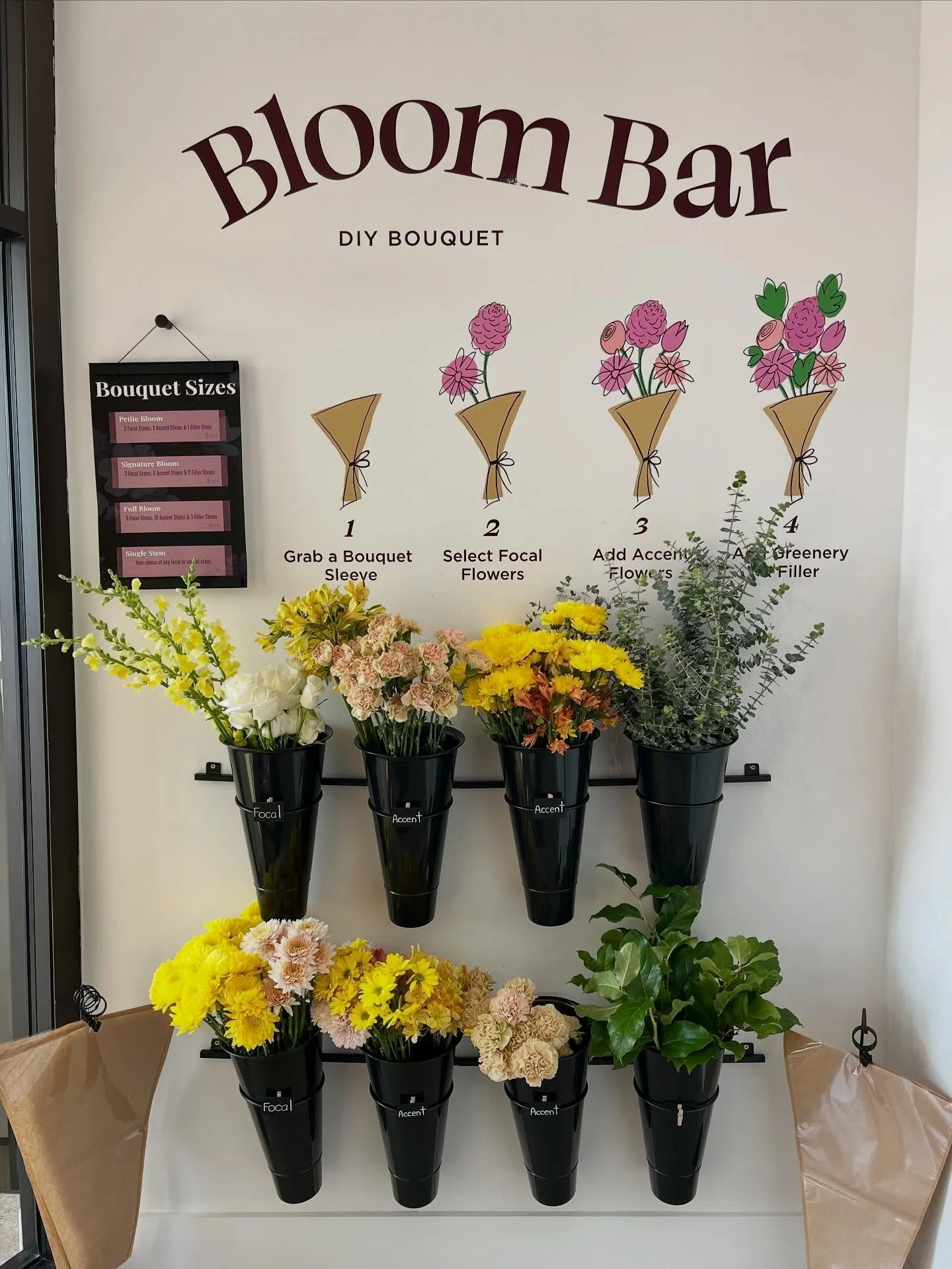 It&rsquo;s spring (!) and the bouquet wall at @thebloomingbrewcafe is lookin&rsquo; real cute today. 🌼 

Client: @rogueawakening 

#mural #flowermural #diybouquet #buildyourownbouquet