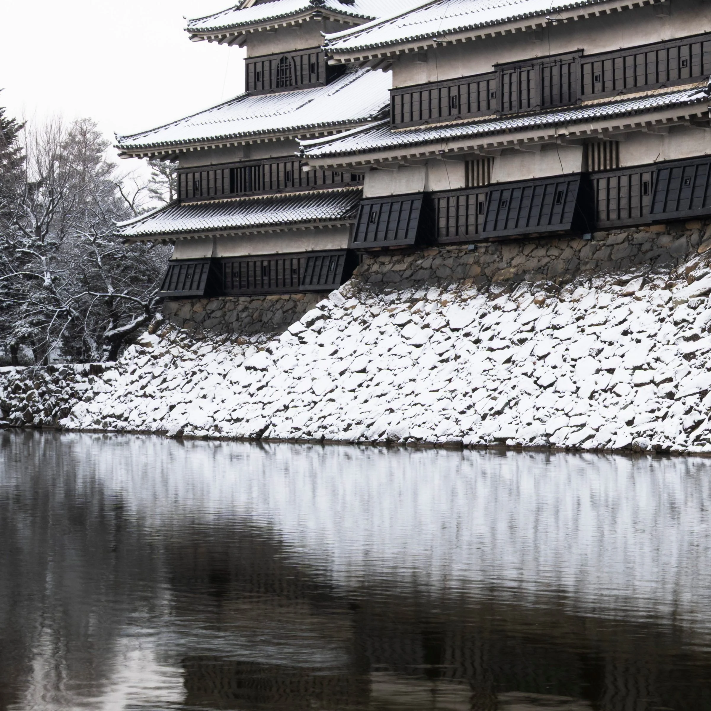 Bottom left zoom detail of the Ice Ice Outpost print, snow covered moat wall below Matsumoto Castle, Nagano, Japan