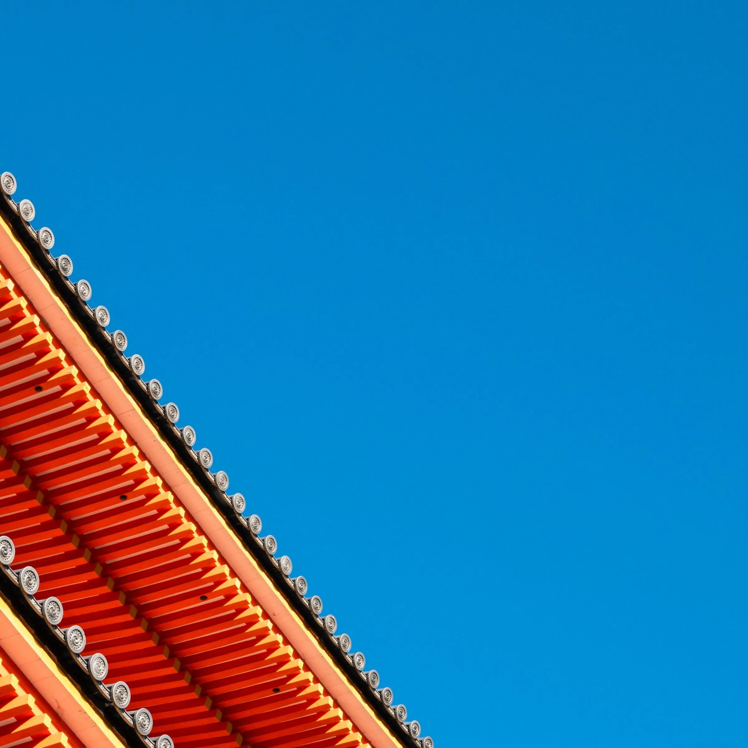 Top right zoom detail of the Dragon Driftway print, pagoda roof tiers against clear blue sky, Kiyomizu-dera, Kyoto, Japan