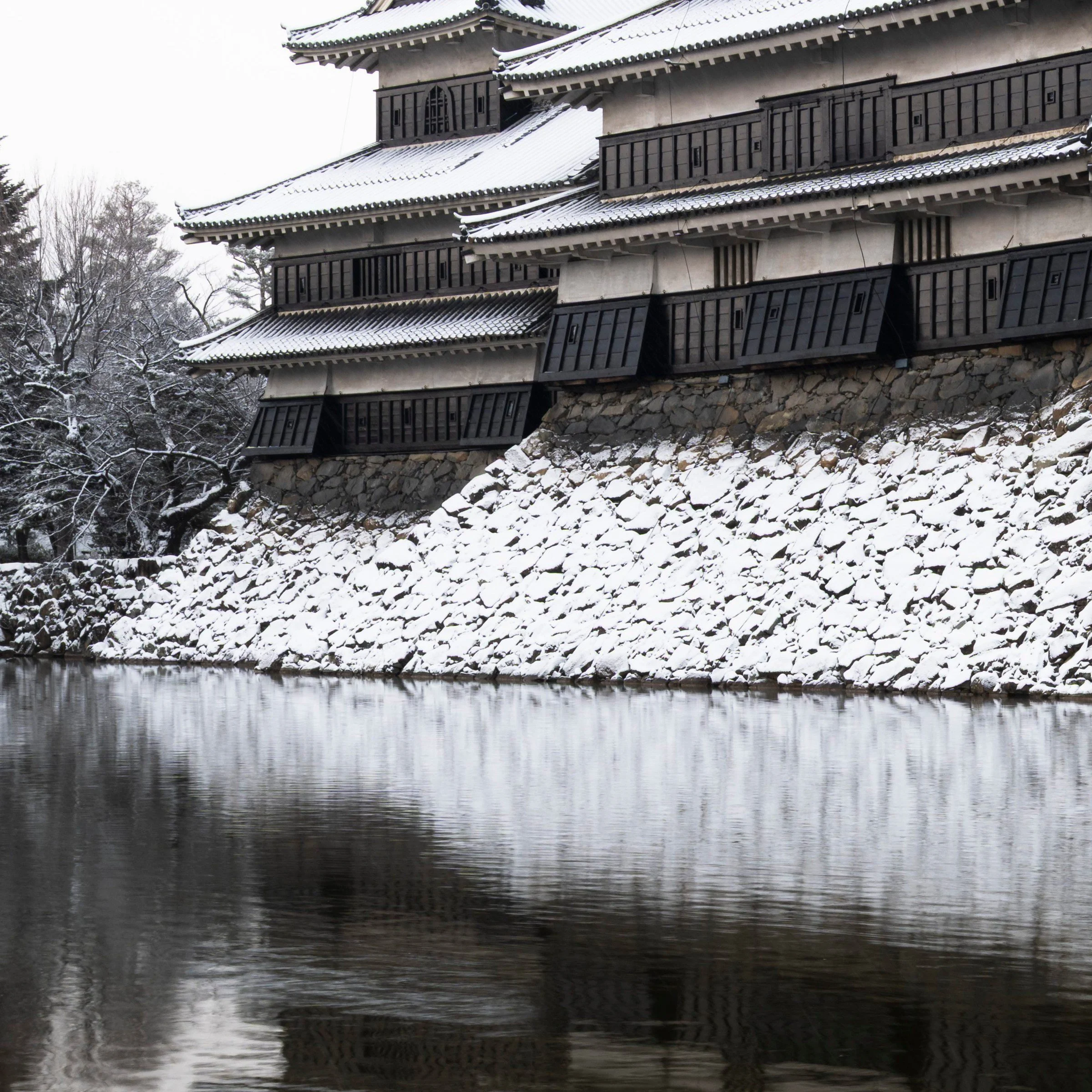 Bottom left zoom detail of the Ice Ice Outpost print, snow covered moat wall below Matsumoto Castle, Nagano, Japan