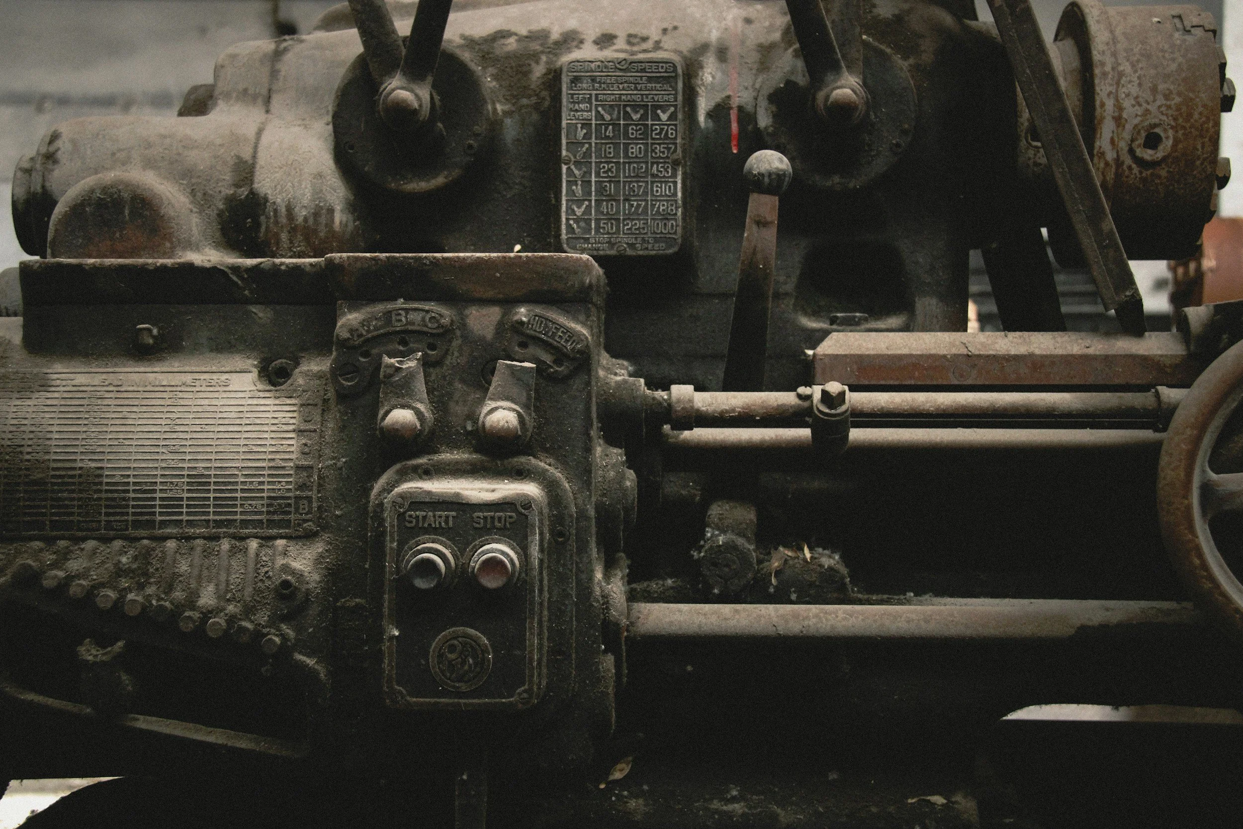 Close-up of an old, dusty engine with various labels and mechanical parts.
