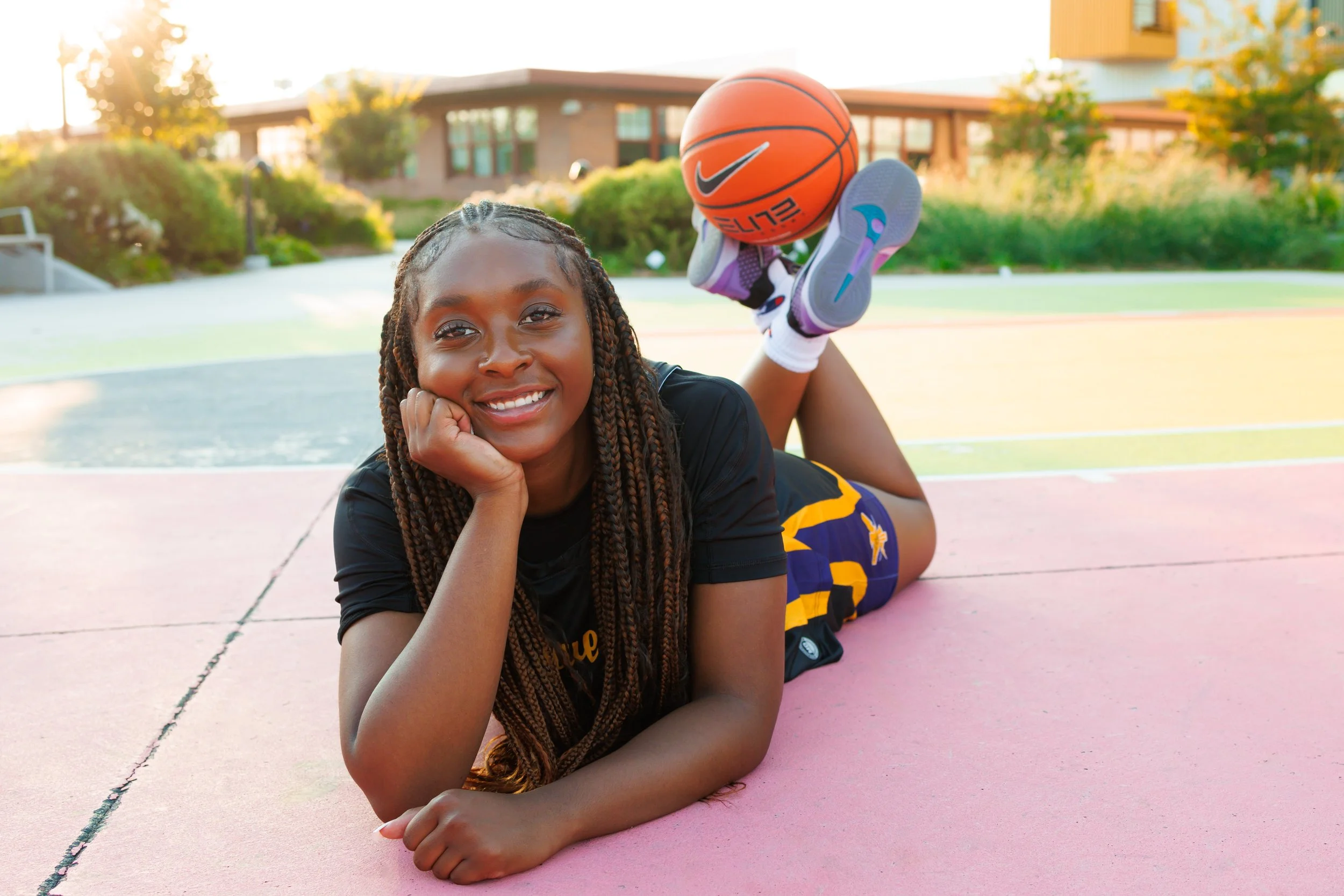 senior photo of a girl with a basketball in downtown Omaha, NE