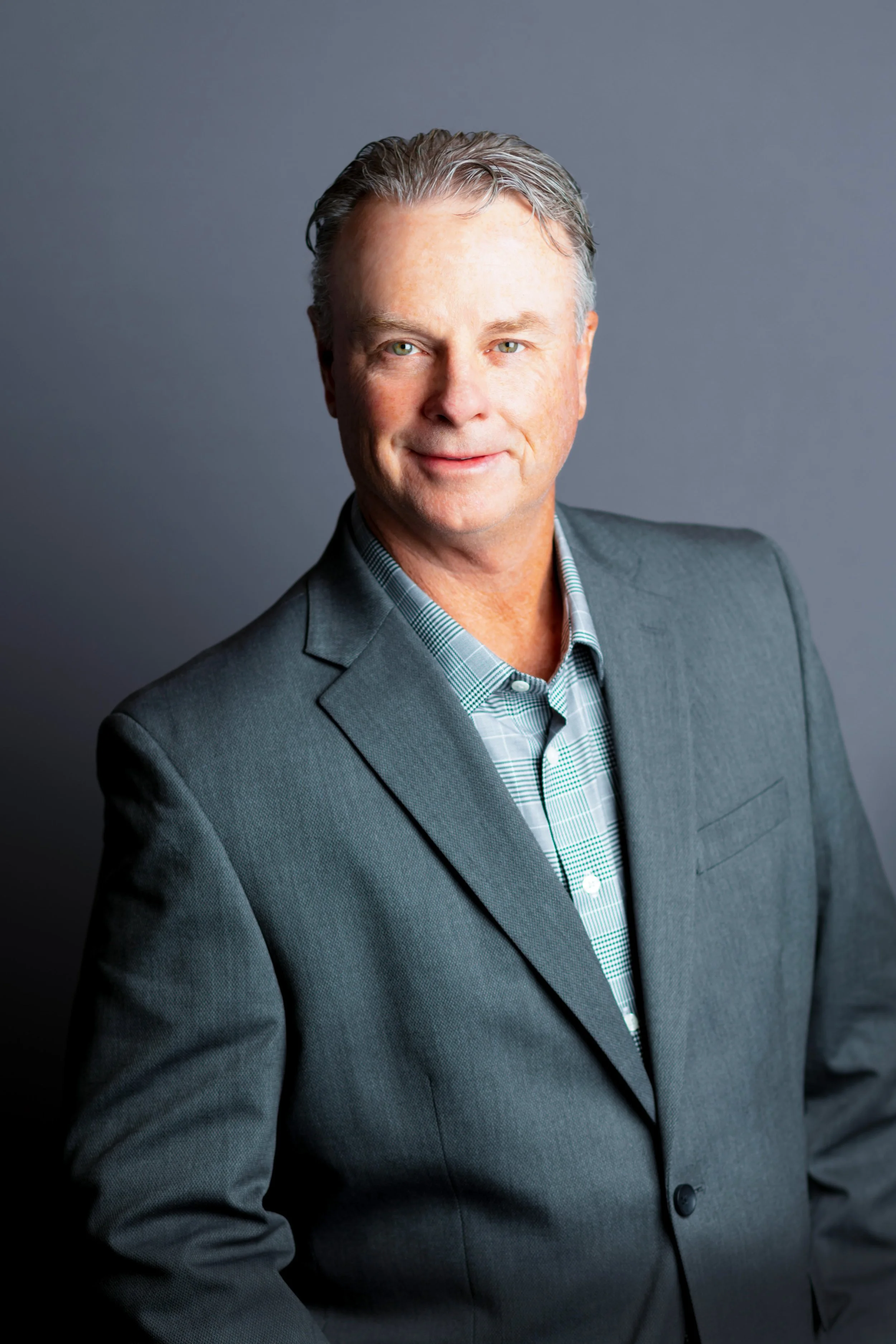 Professional Headshot of man in gray suit