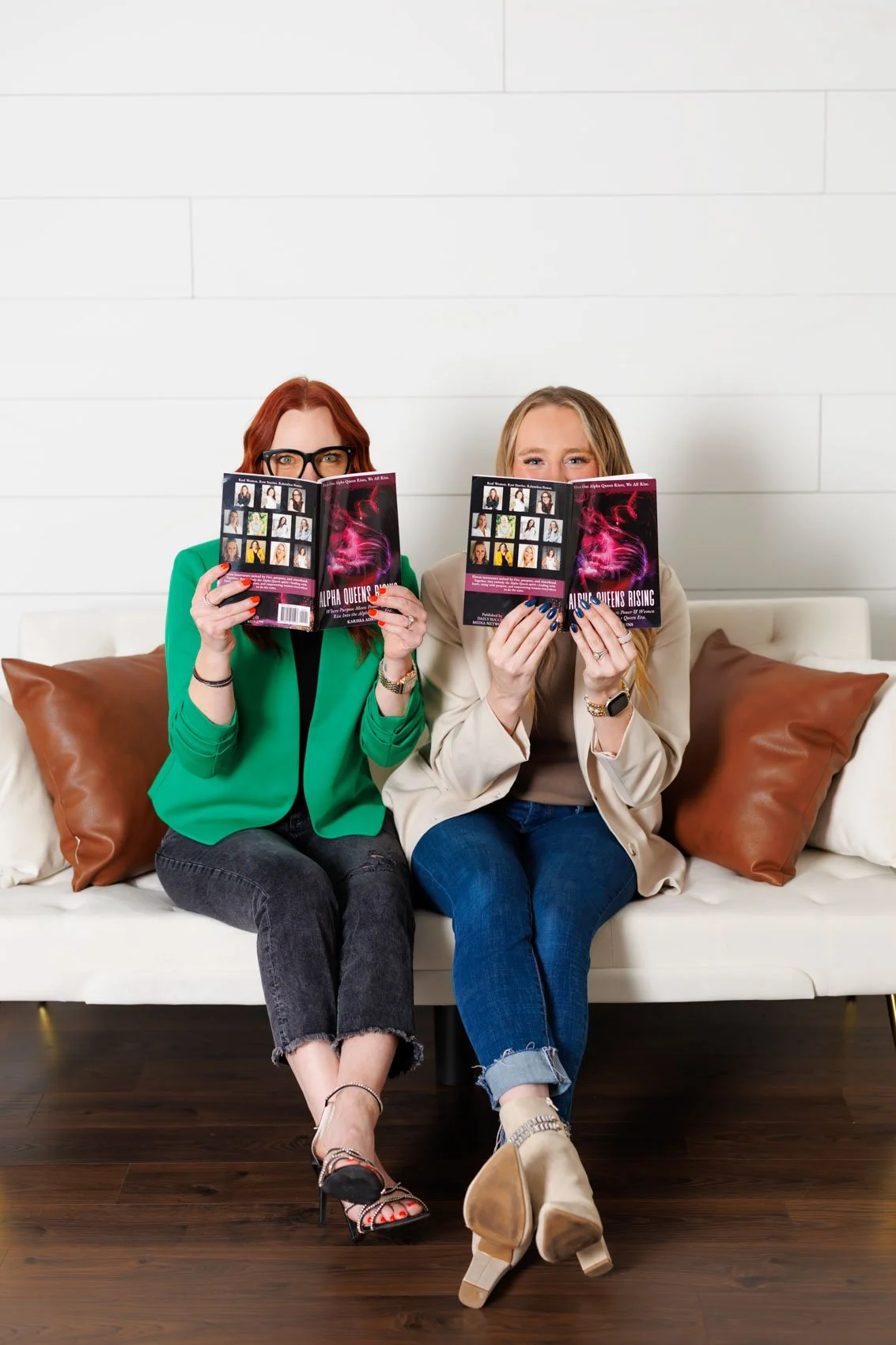 photo of two authors with their book, sitting on a couch