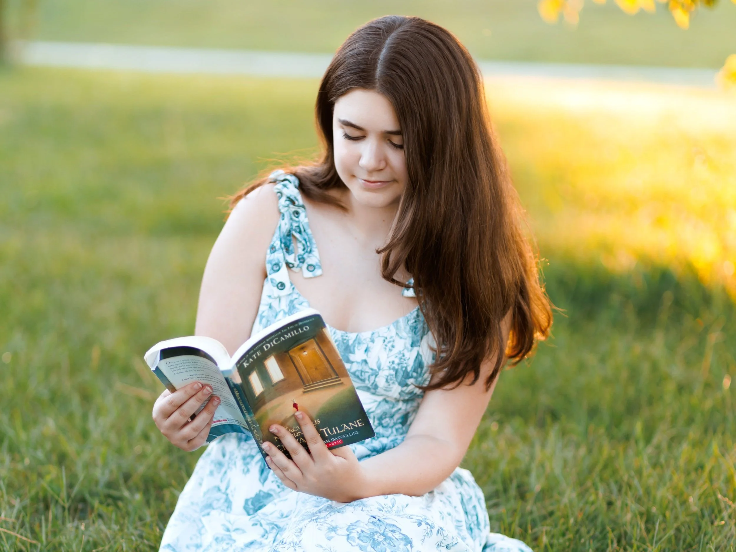 senoir photo of a girl reading a book in Gretna, NE