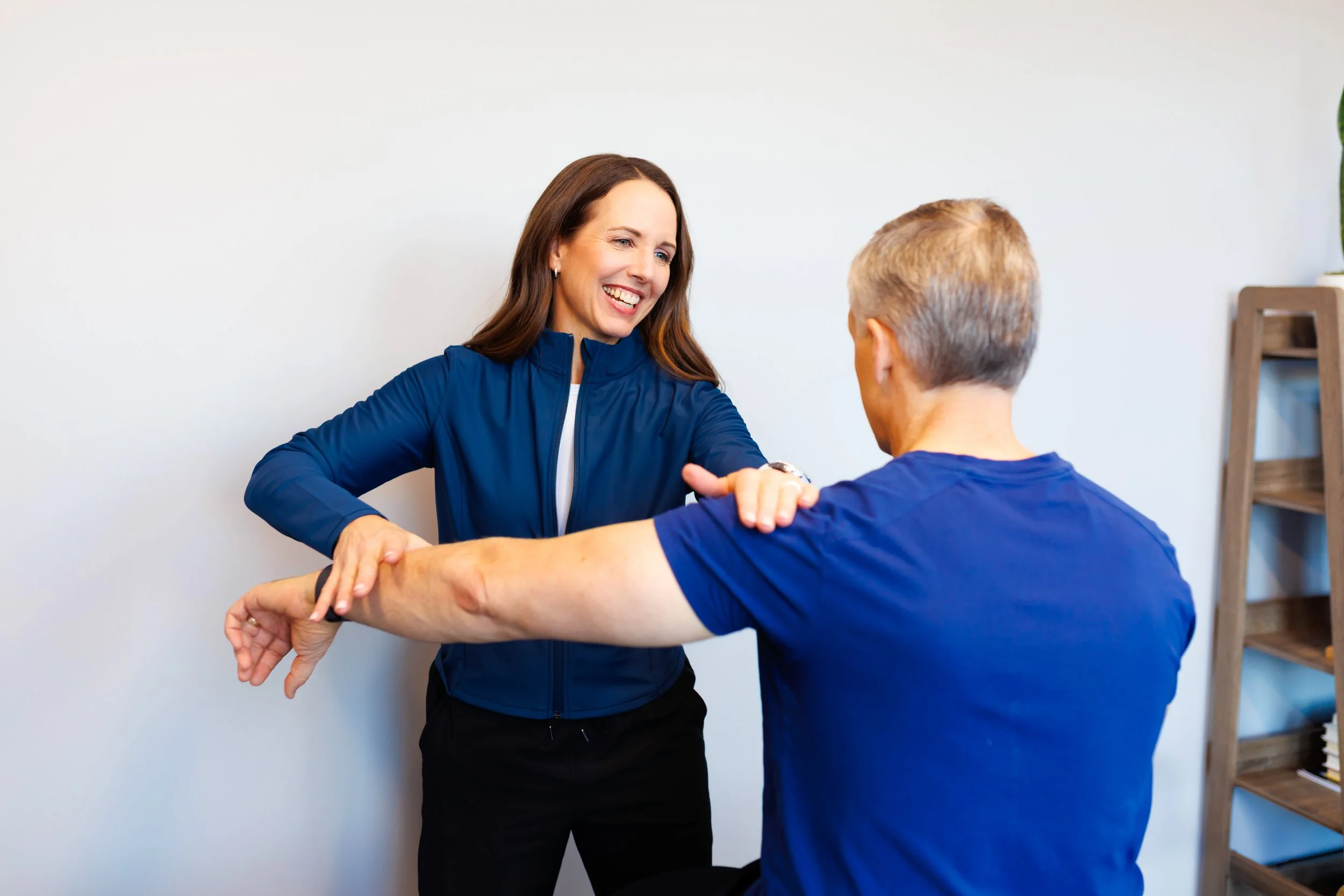 branding photo of Physcial Therapist helping someone with shoulder exercises