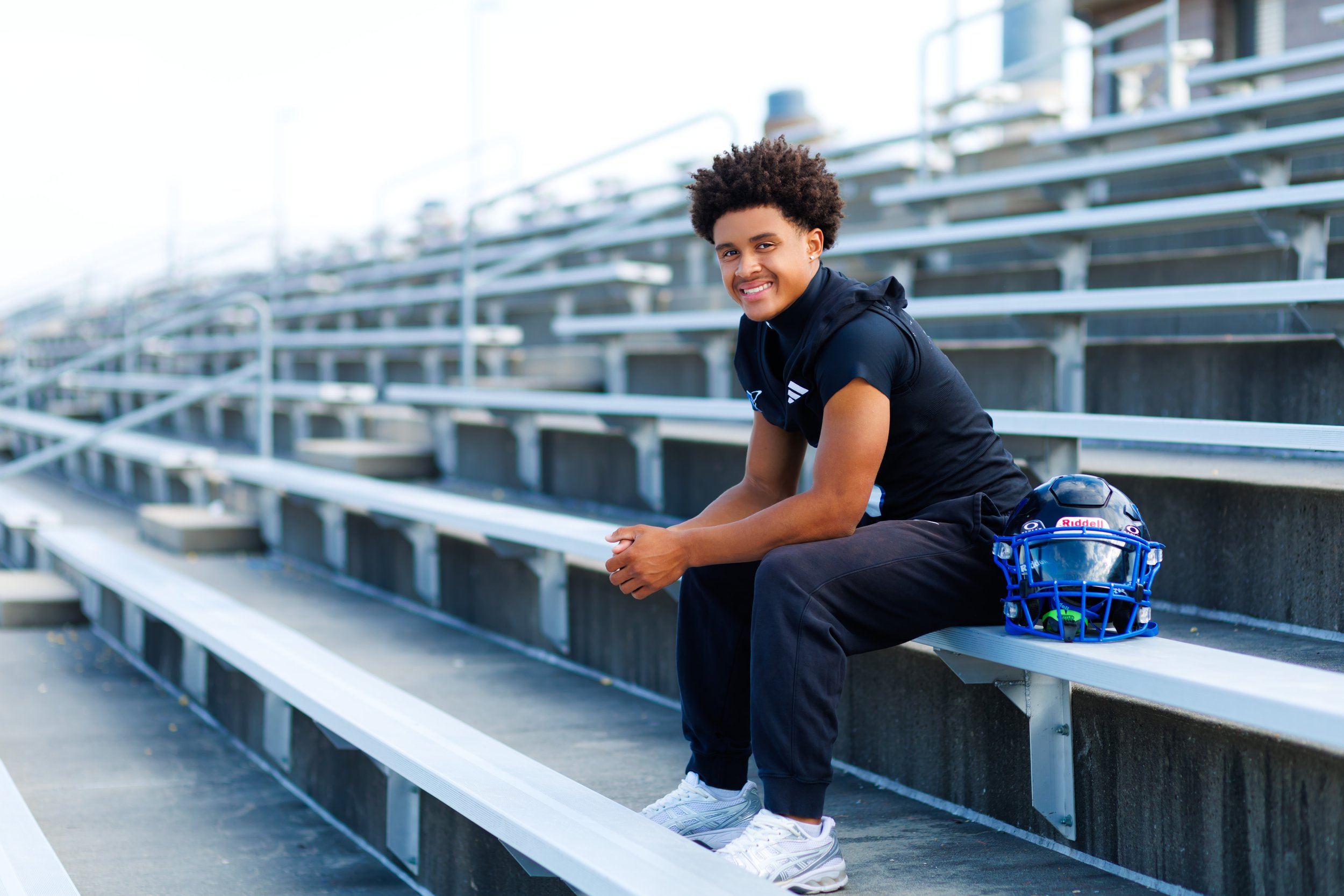 senior photo of a boy on football bleachers