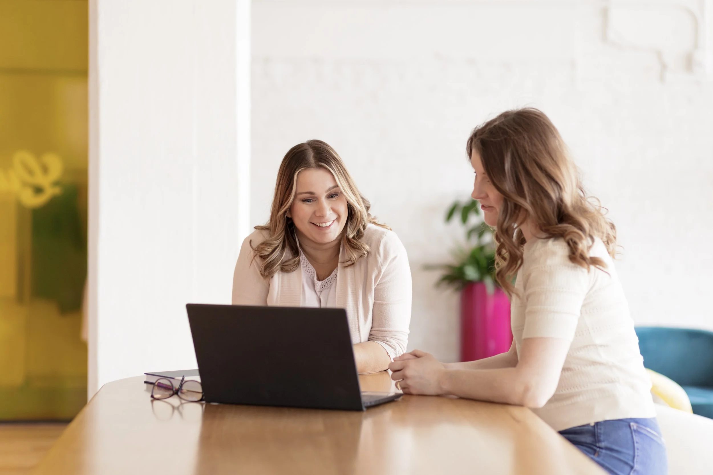 photo of two women looking at a computer