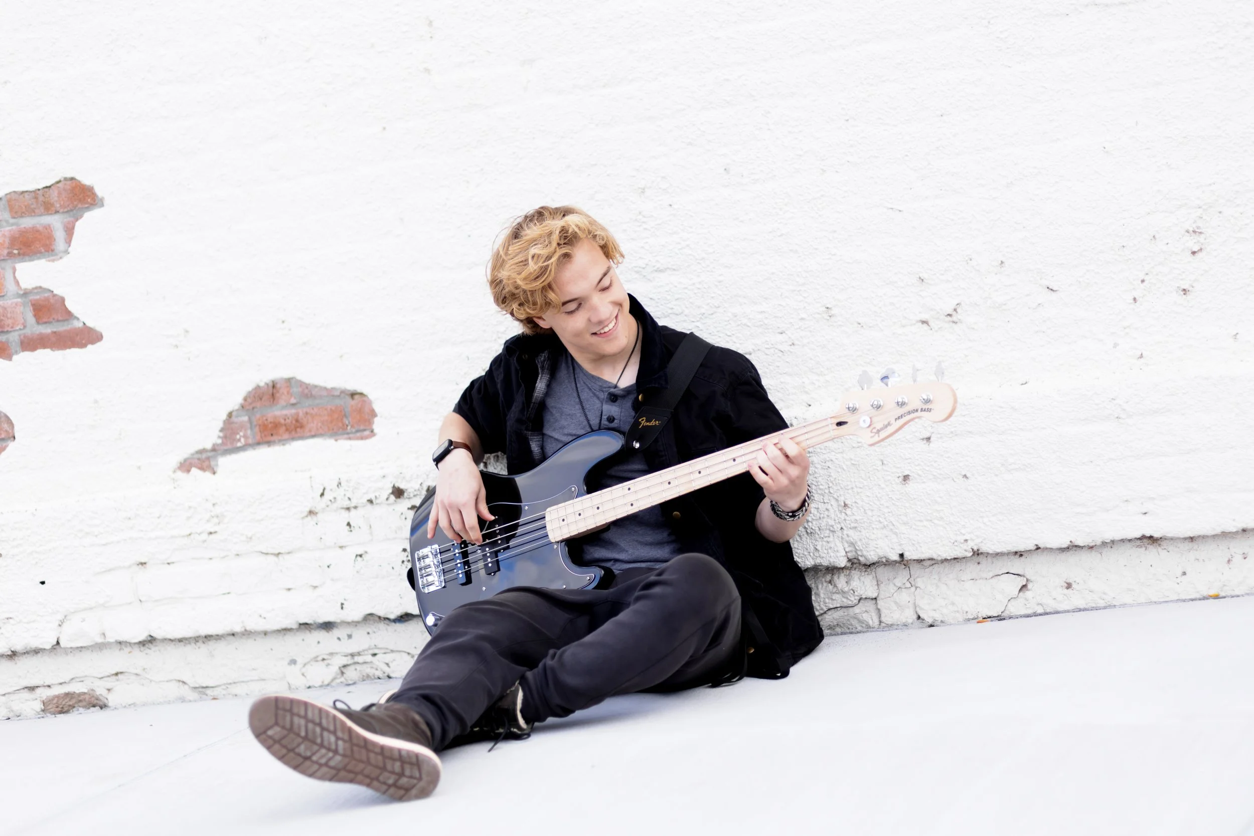 senior photo of a boy playing his guitar in Papillion, NE