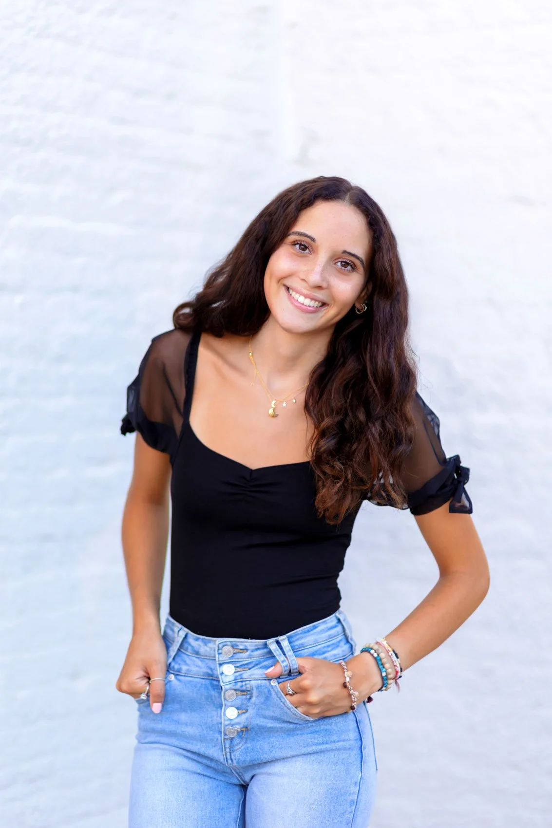 senior photo of a girl in a black top and jeans in Papillion, NE