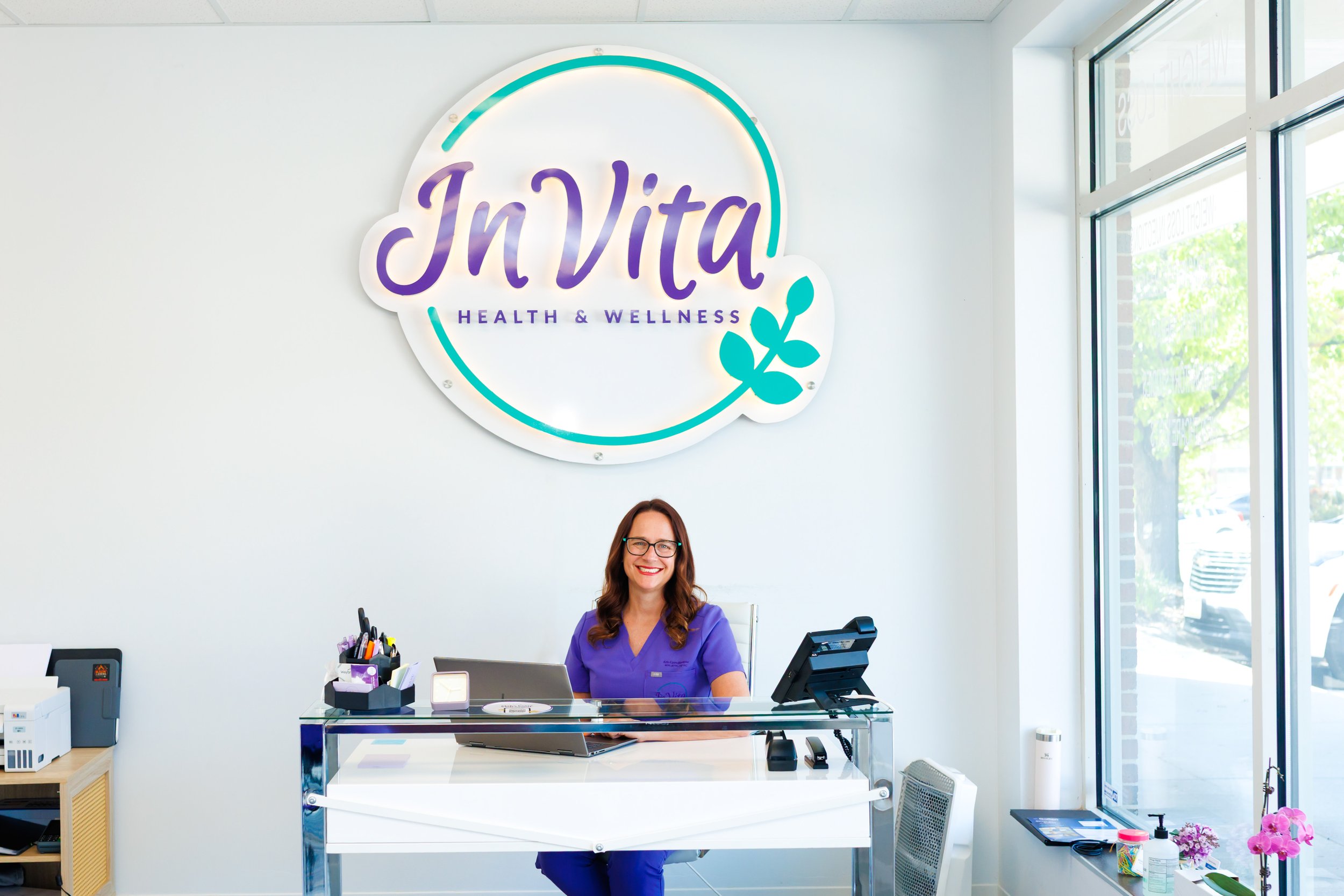 branding photo of woman nurse practitioner waiting at her desk for clients