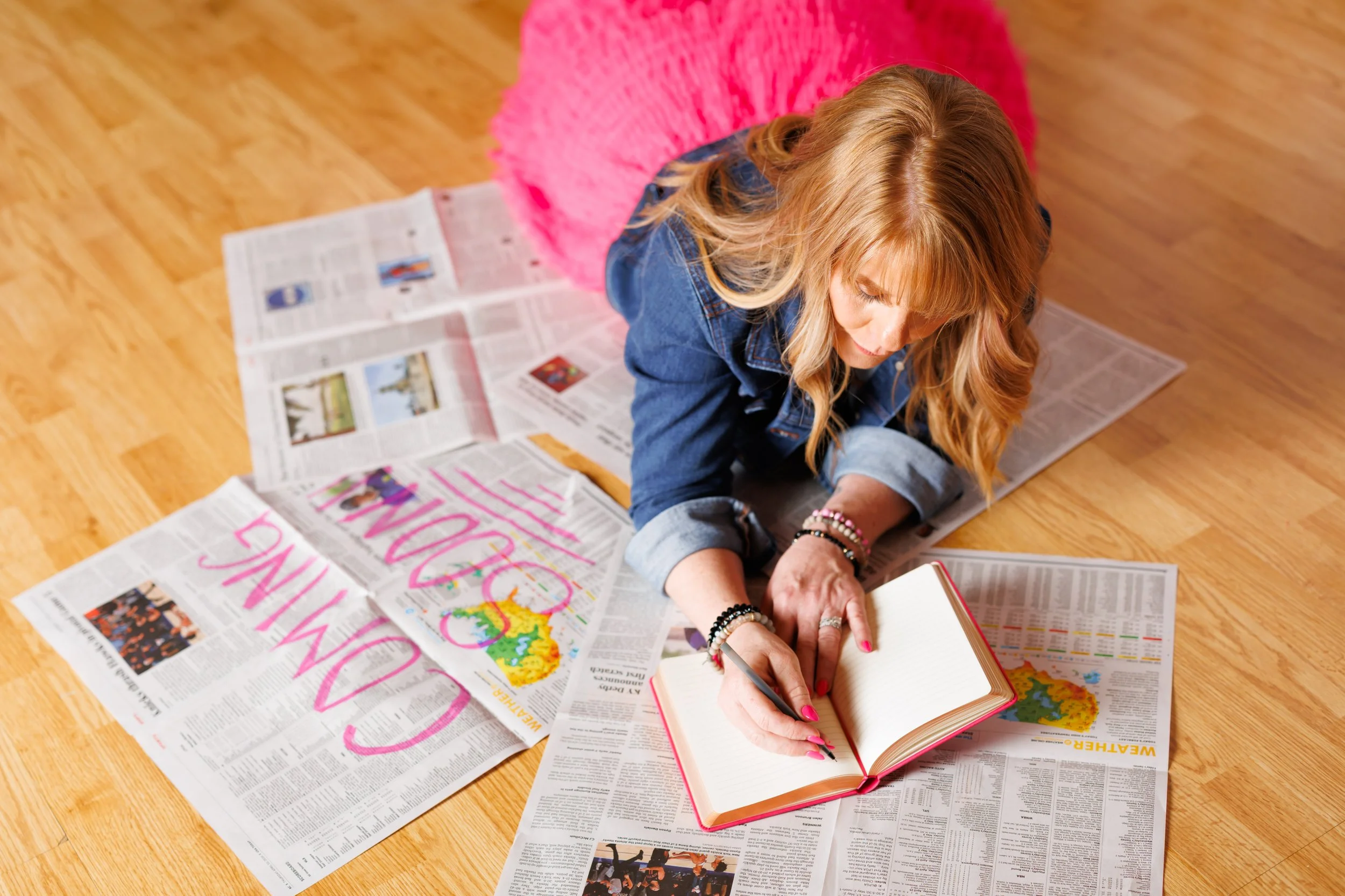 branding photo of a woman laying on the ground planning her next event