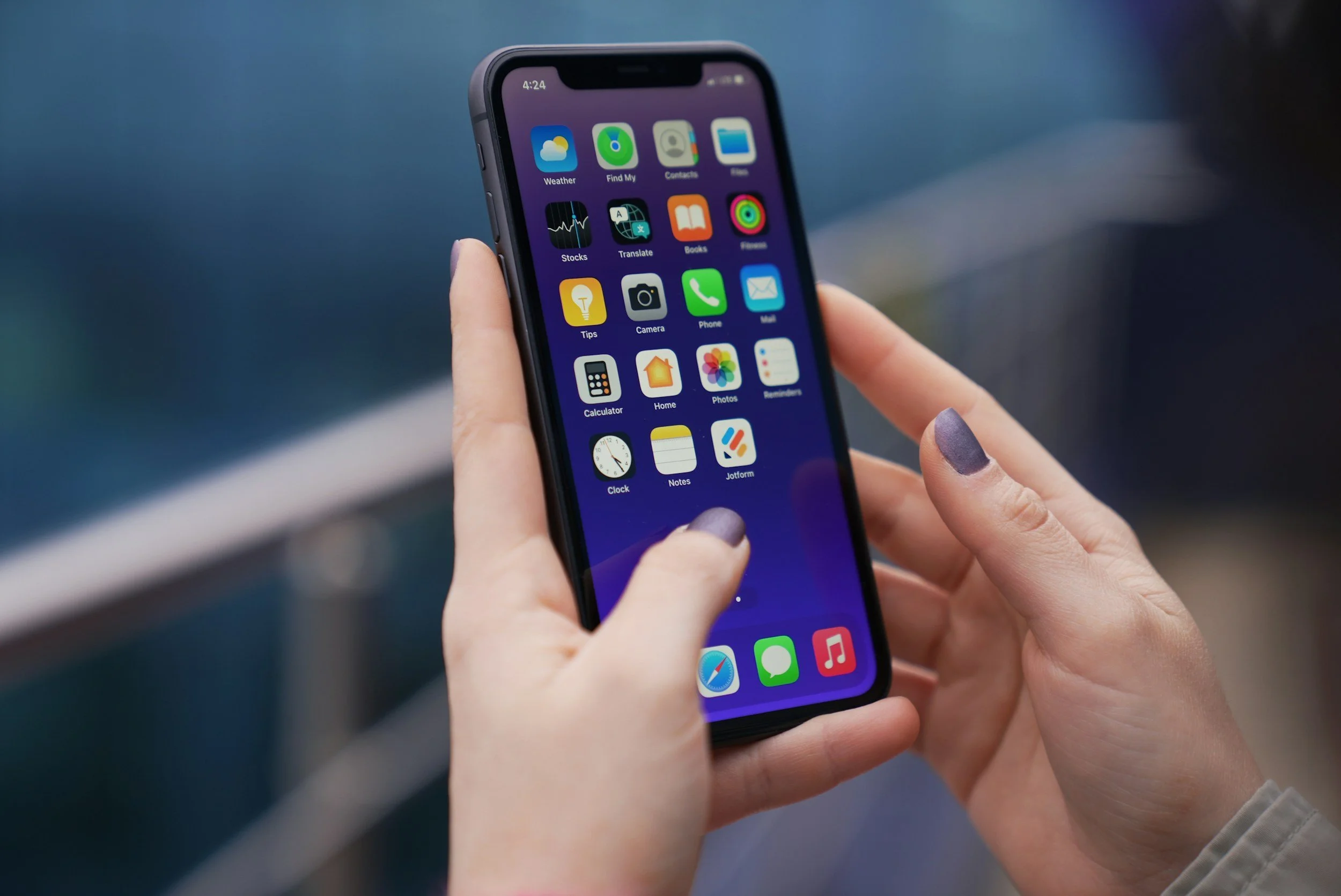 Hands typing on a phone to reach out and schedule therapy in Olney, MD or via telehealth