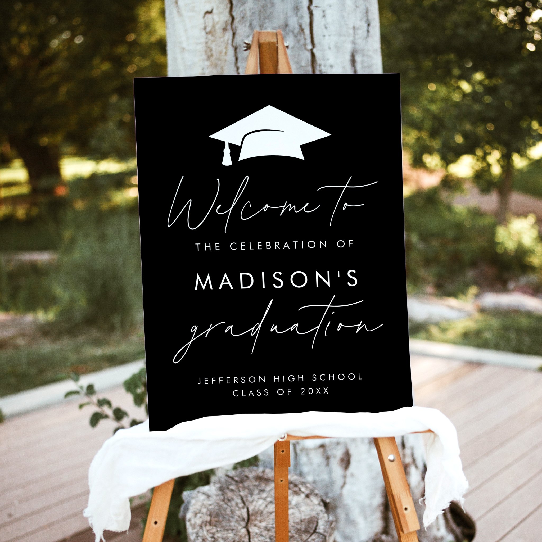 Personalized black graduation party welcome sign with white text, graduation cap icon, and script accents
