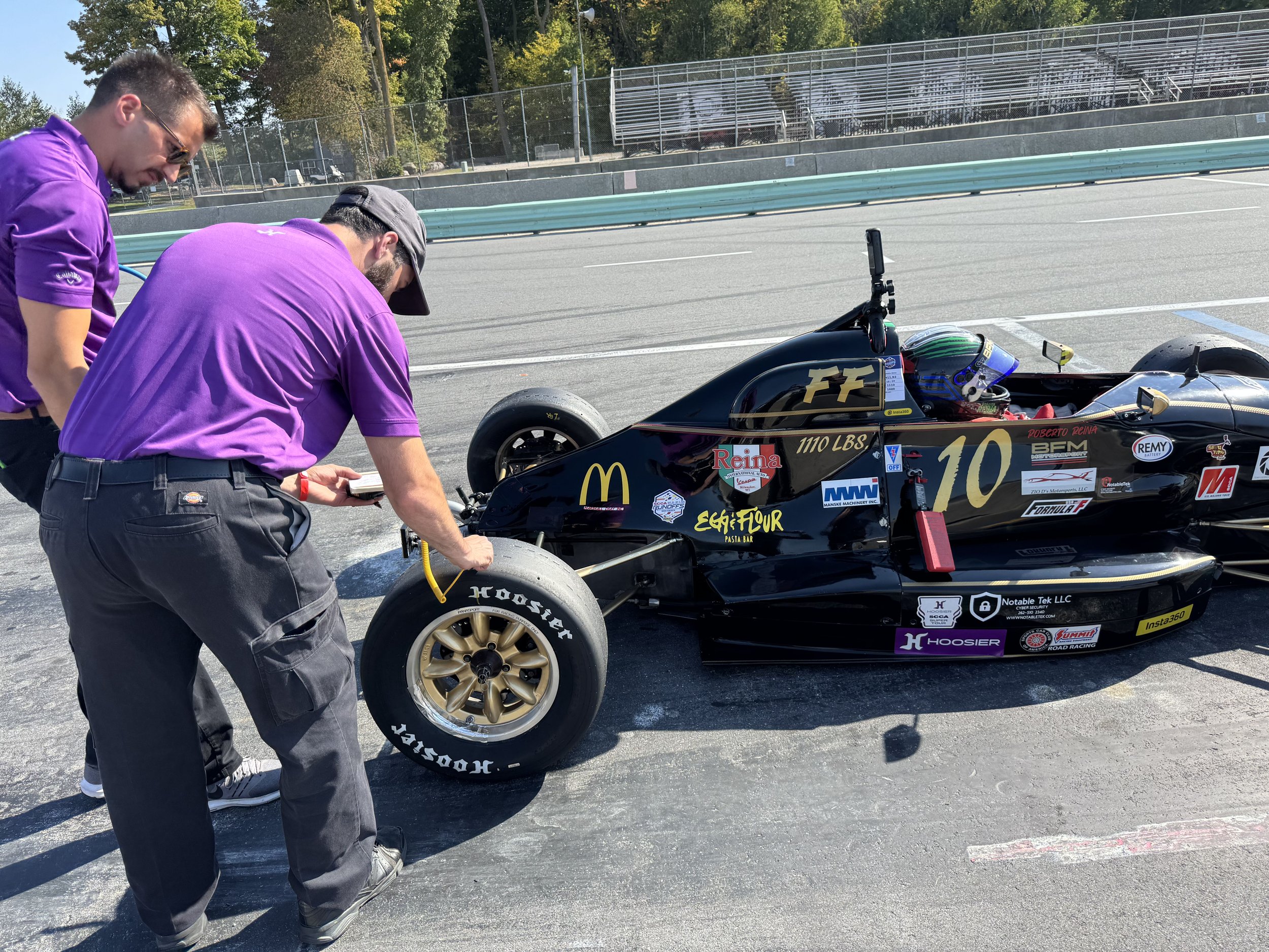 Hoosier techs checking tires at the 2025 Runoffs