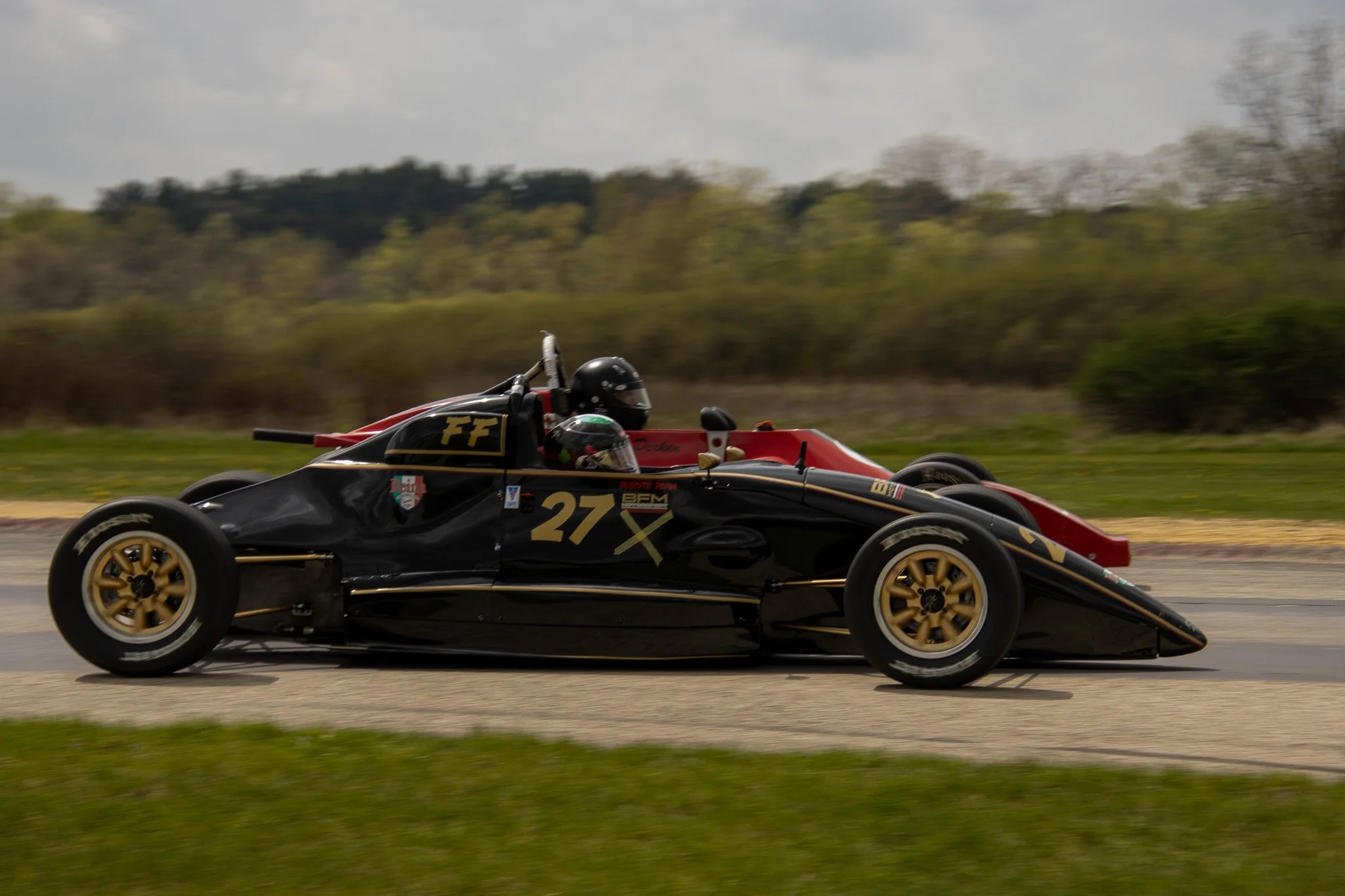 A black and gold vintage number 27 driven by Filippo Reina.