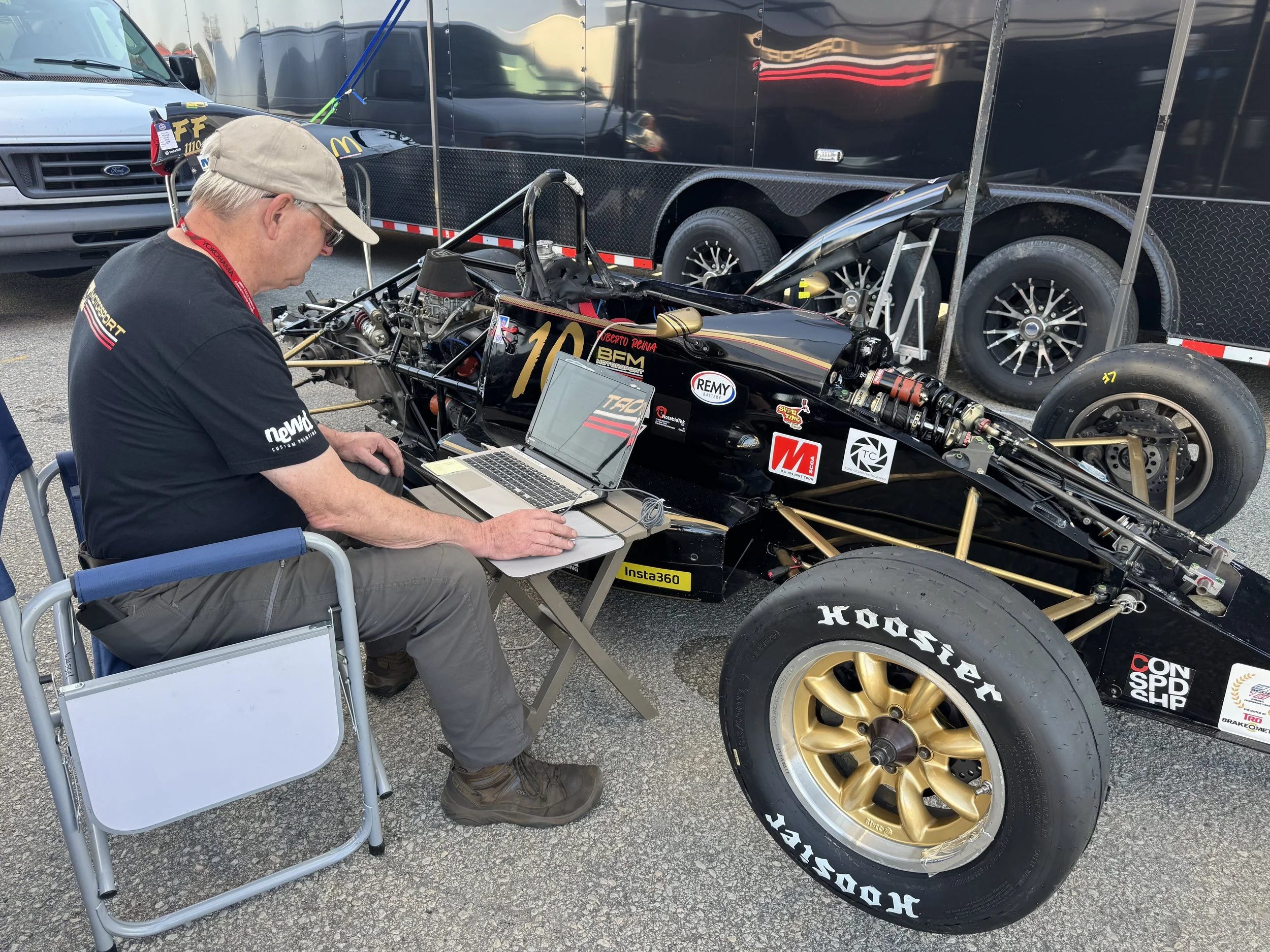 BFM Motorsport crew member tuning up the Van Diemen
